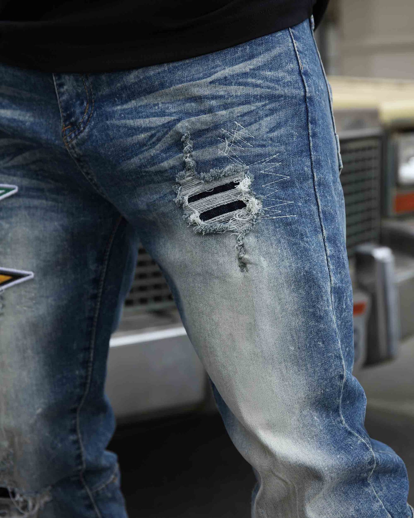 Logeqi medium wash distressed jeans featuring unique rips and a stylish fit