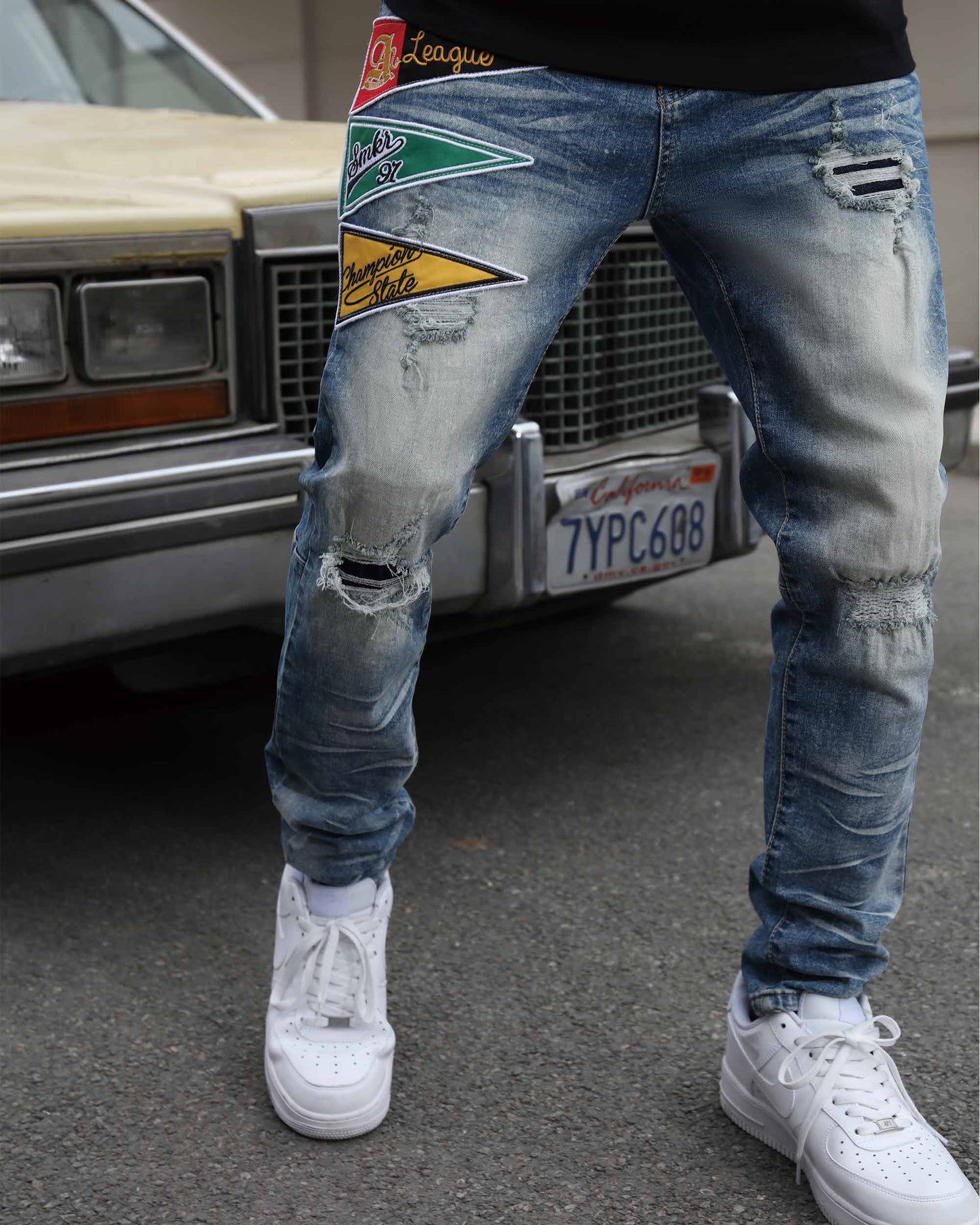 Logeqi medium wash distressed jeans featuring patches and ripped detailing for a trendy look