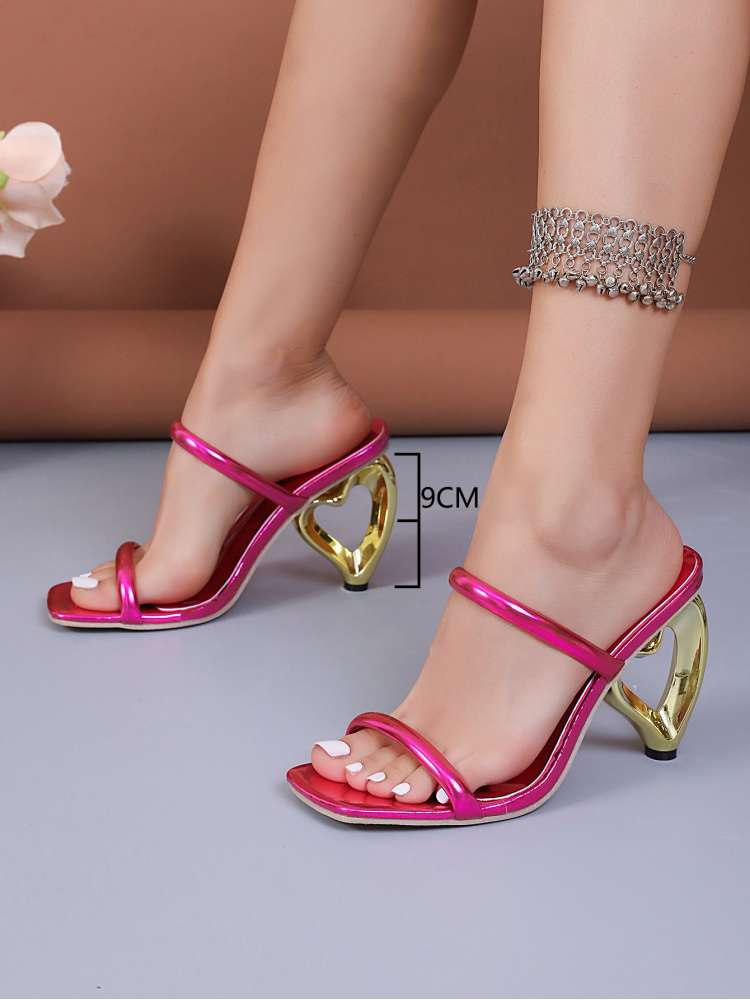 Wholesale7 metallic heart heel slippers in shiny pink with gold heart-shaped heels and open toe design