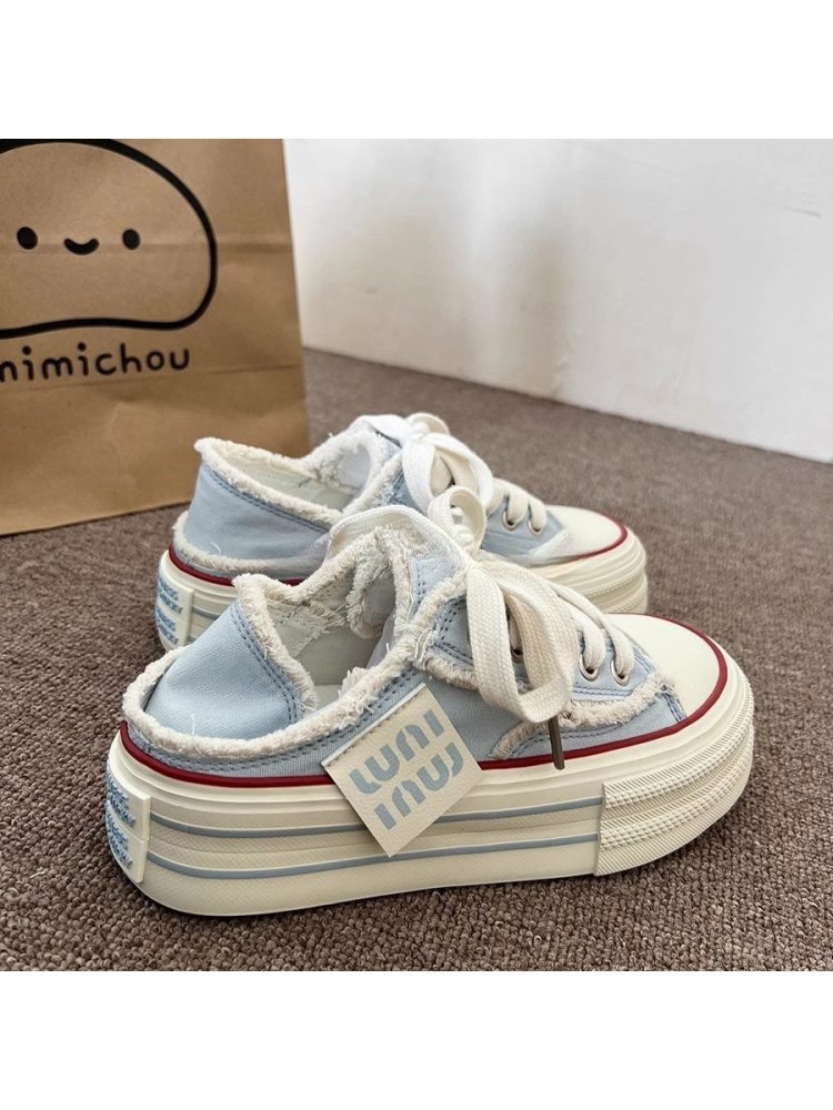 Wholesale7 lace up flat heel slippers in light blue with white laces and fluffy inner lining