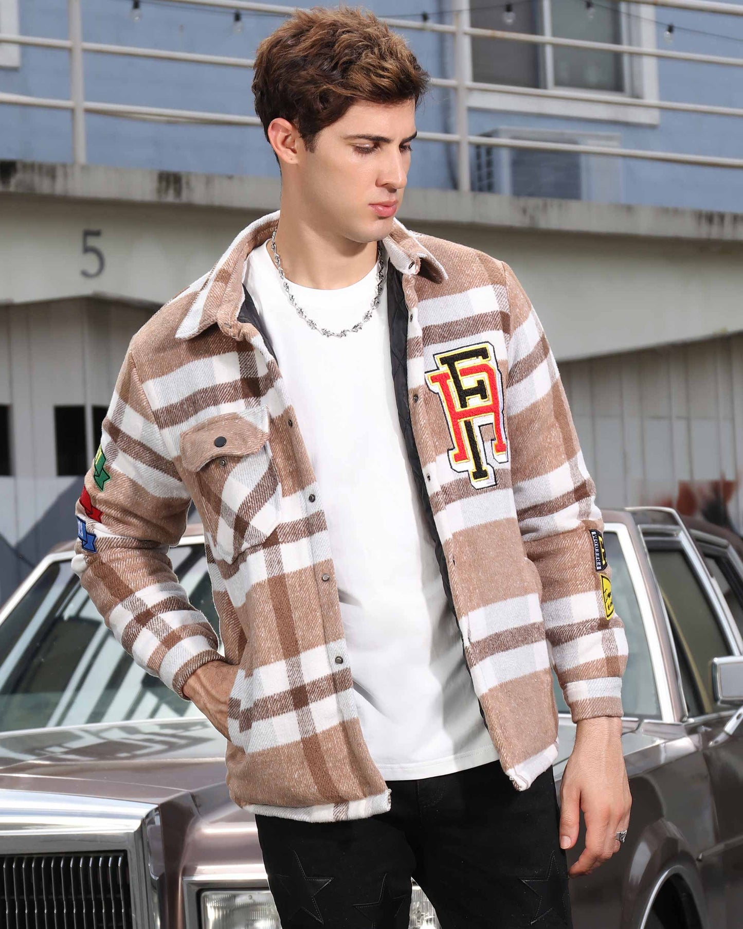 Logeqi modern plaid moto jacket in brown and white plaid with patches worn by male model