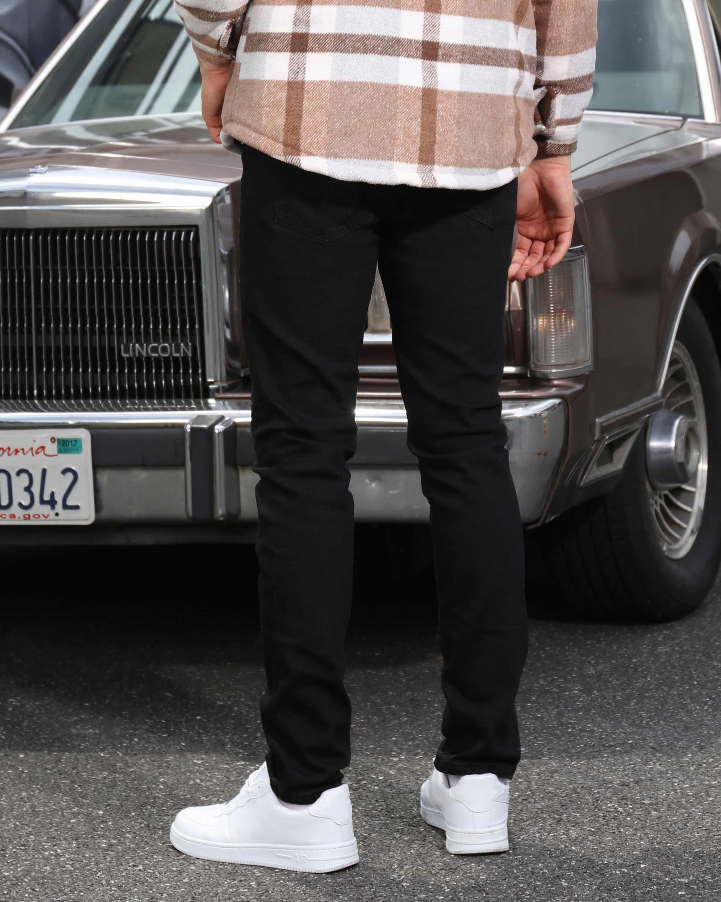 Back view of modern plaid moto jacket by Logeqi worn with black pants and white sneakers