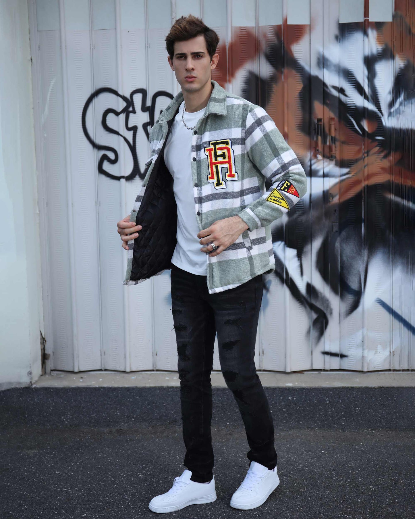 Man wearing Logeqi modern plaid moto jacket in green and white while posing outdoors