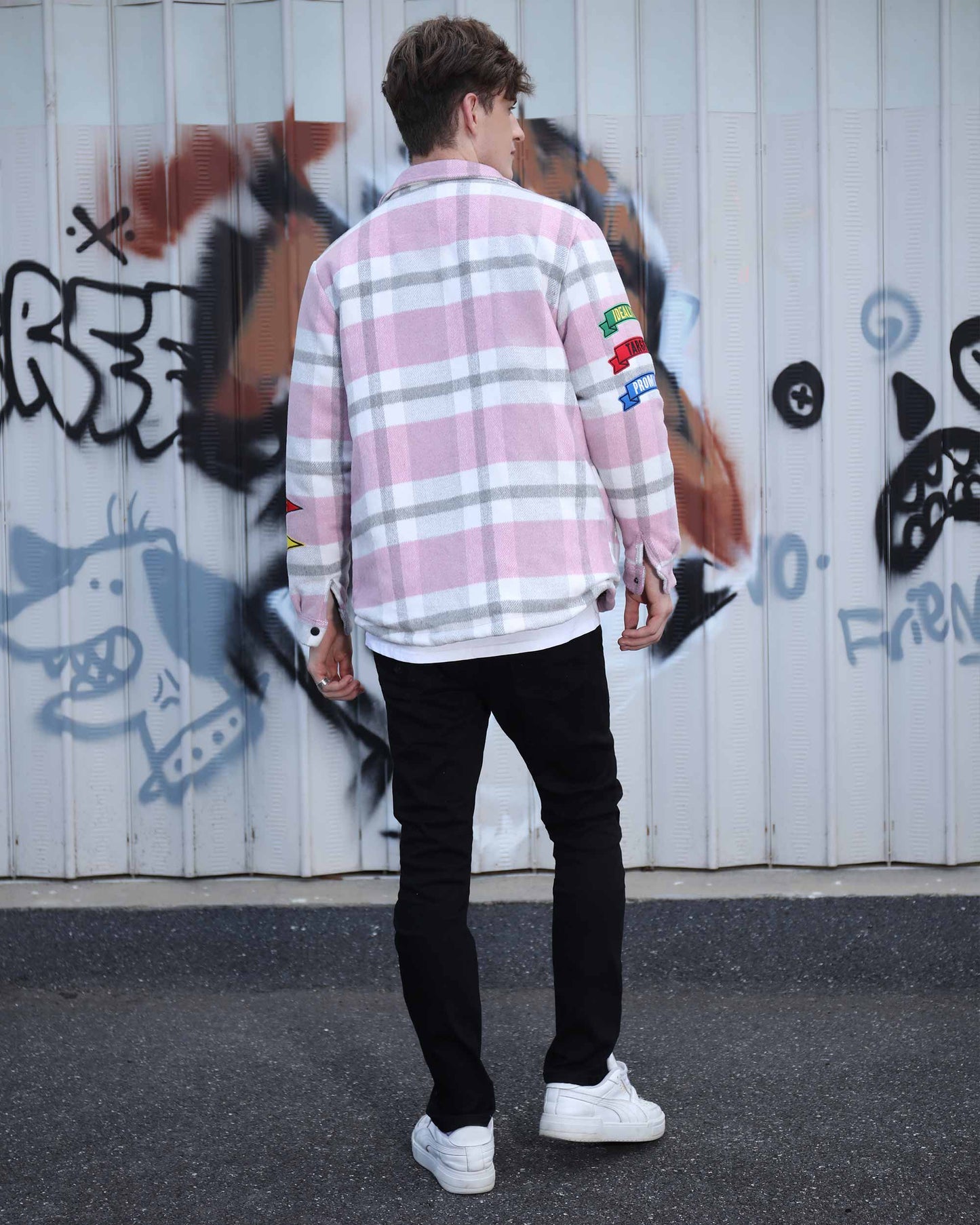 Logeqi modern plaid moto jacket in pink and white worn by male model against graffiti wall