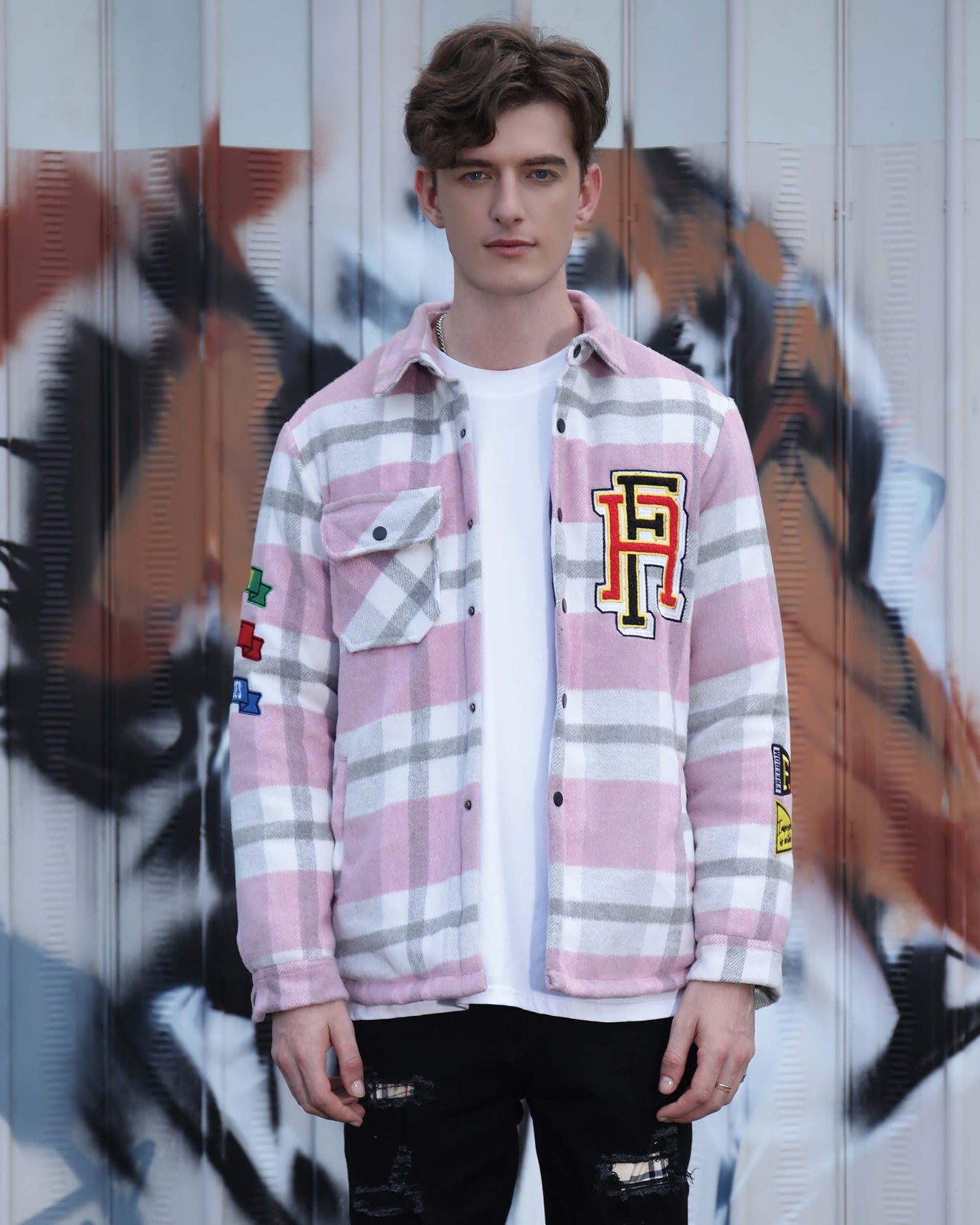Logeqi modern plaid moto jacket in pink and white worn by male model with black distressed jeans