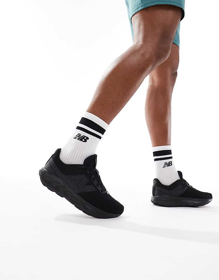 Men wearing black New Balance 520 running shoes with white branded socks in motion