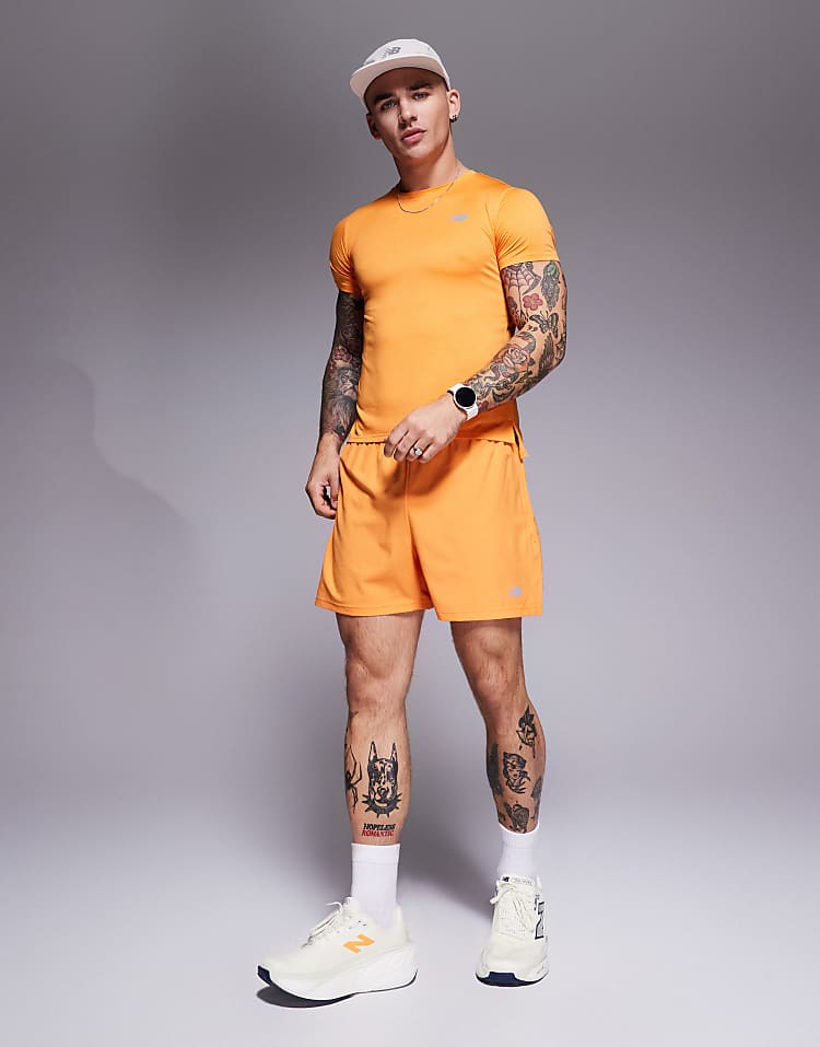 Man wearing orange athletic outfit and white New Balance running shoes from Modan Online for men