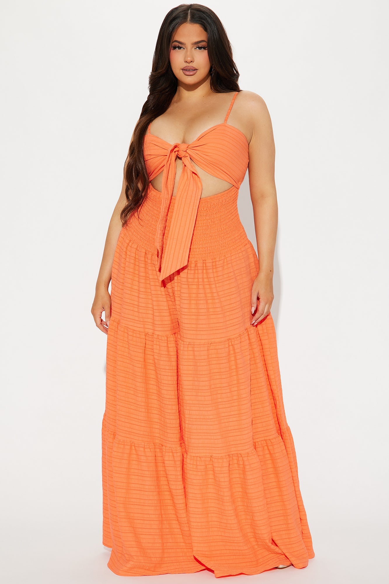 Fashion Nova orange jumpsuit for women with a tie-front top and tiered skirt design