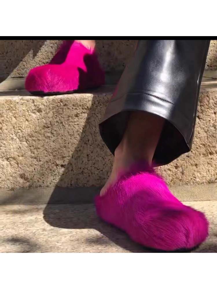 Pink flat heel slippers with soft furry texture worn outdoors on steps from wholesale7