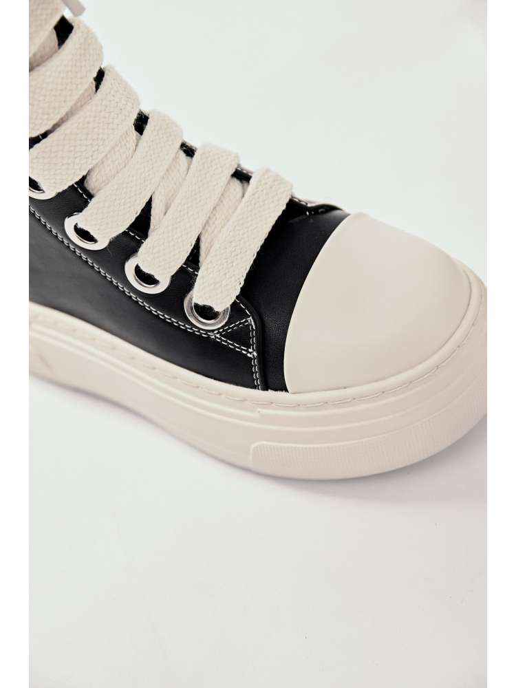 Close-up of black and white platform high top boots with thick white laces and rubber sole
