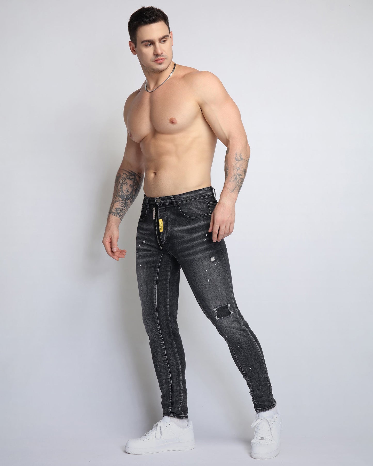 Stylish ripped black jeans for men by Logeqi, featuring a slim fit and distressed accents