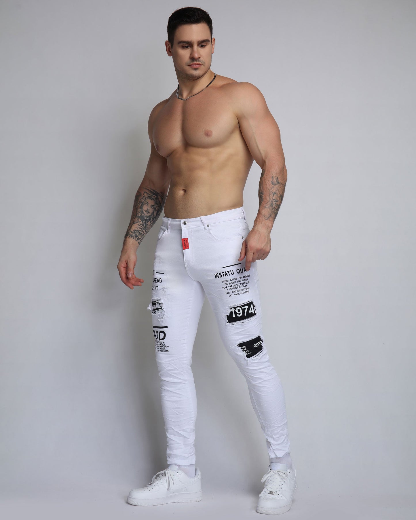 Stylish ripped white jeans with patches, featuring a slim fit and trendy designs for a modern look