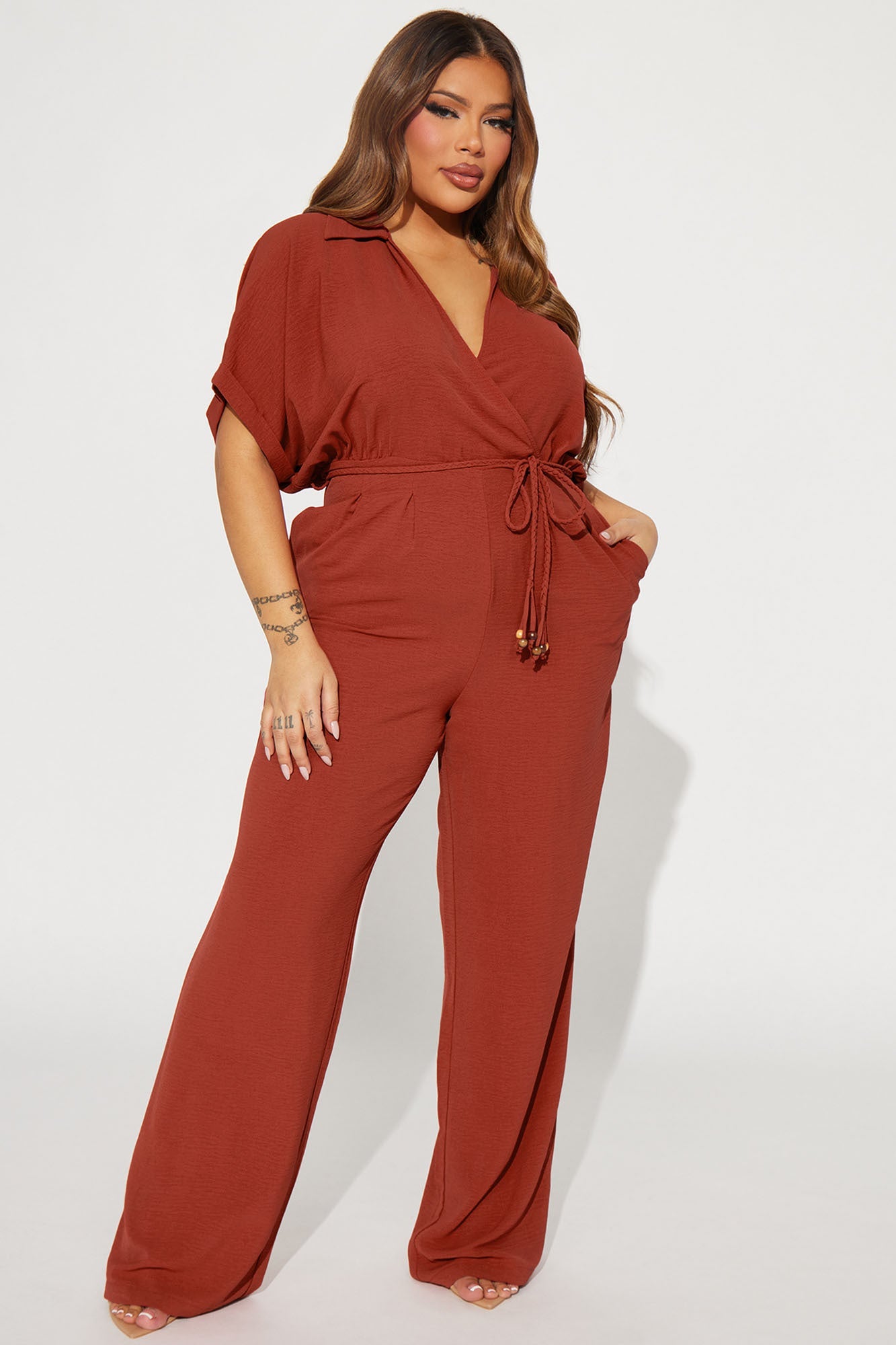 Fashion Nova rust jumpsuit for women with a wrap front and relaxed fit for a stylish look