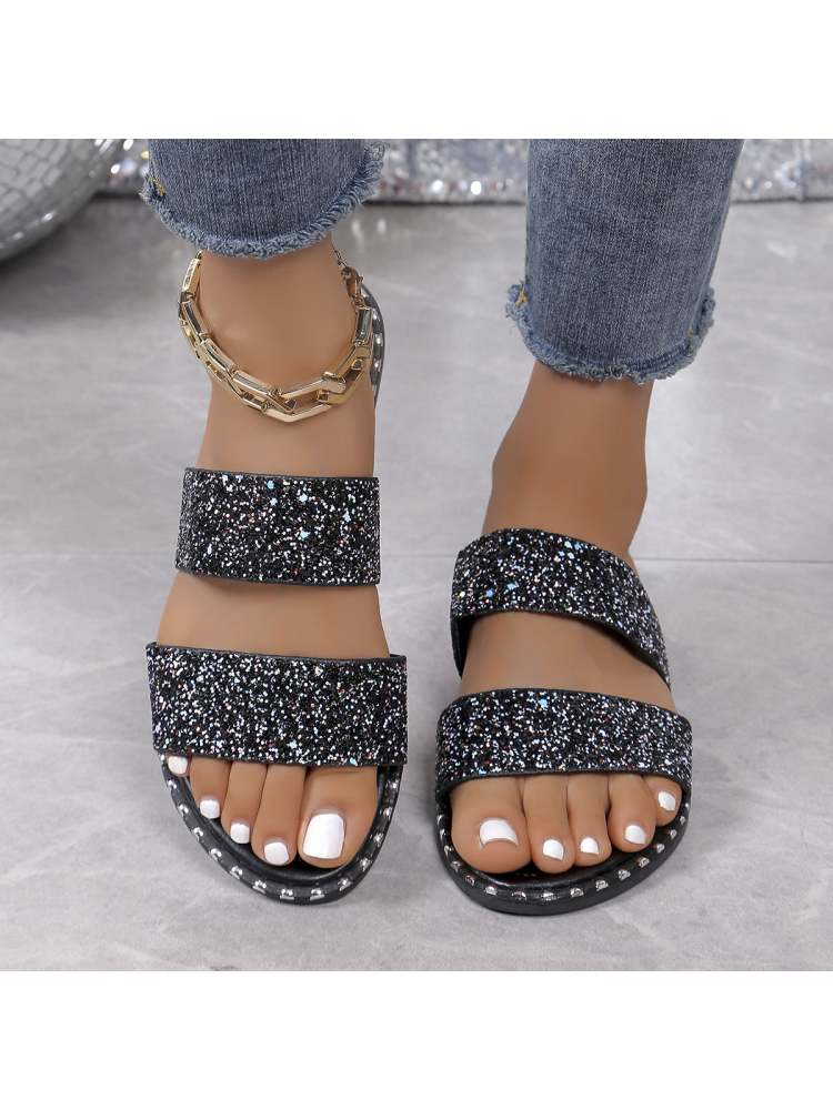 Wholesale7 sequin flat heel slippers with double straps and black sparkly design on feet