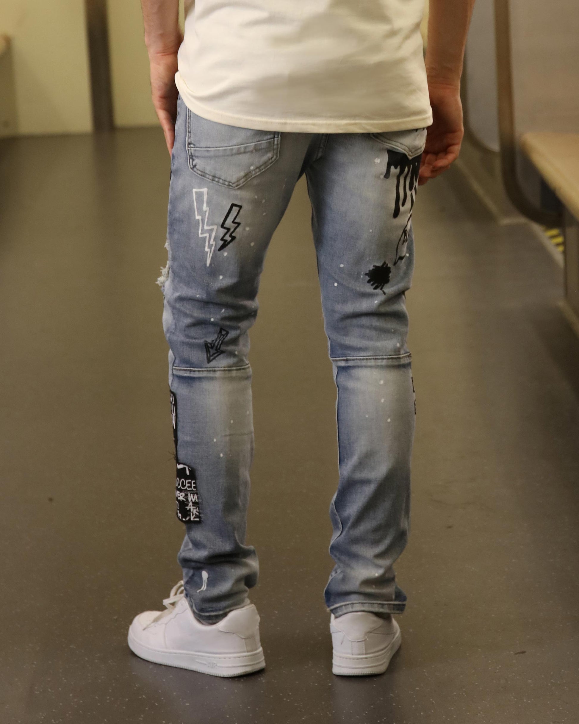 Logeqi skull graffiti ripped jeans in light denim with black graffiti designs and distressed details