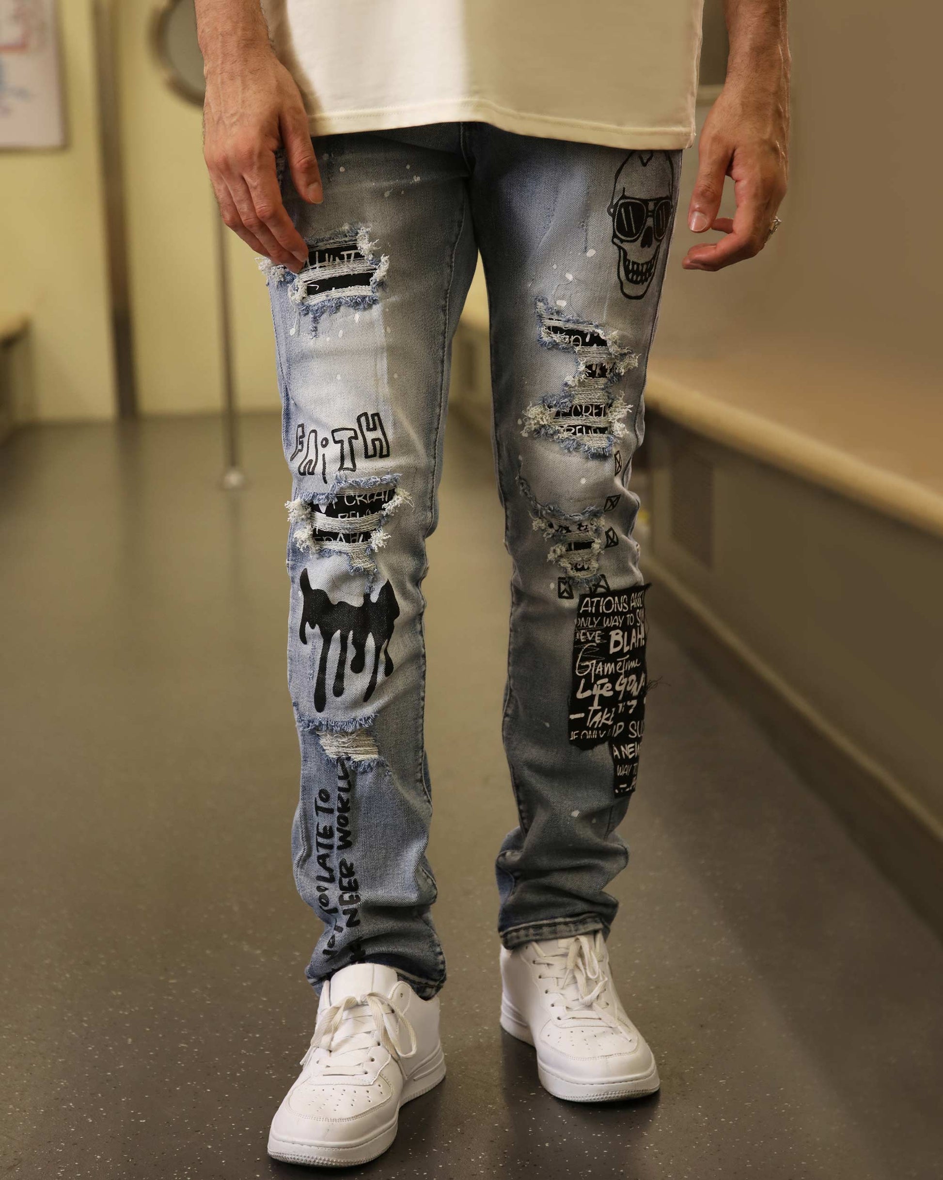 Logeqi skull graffiti ripped jeans with distressed details and artistic black graphics on blue denim