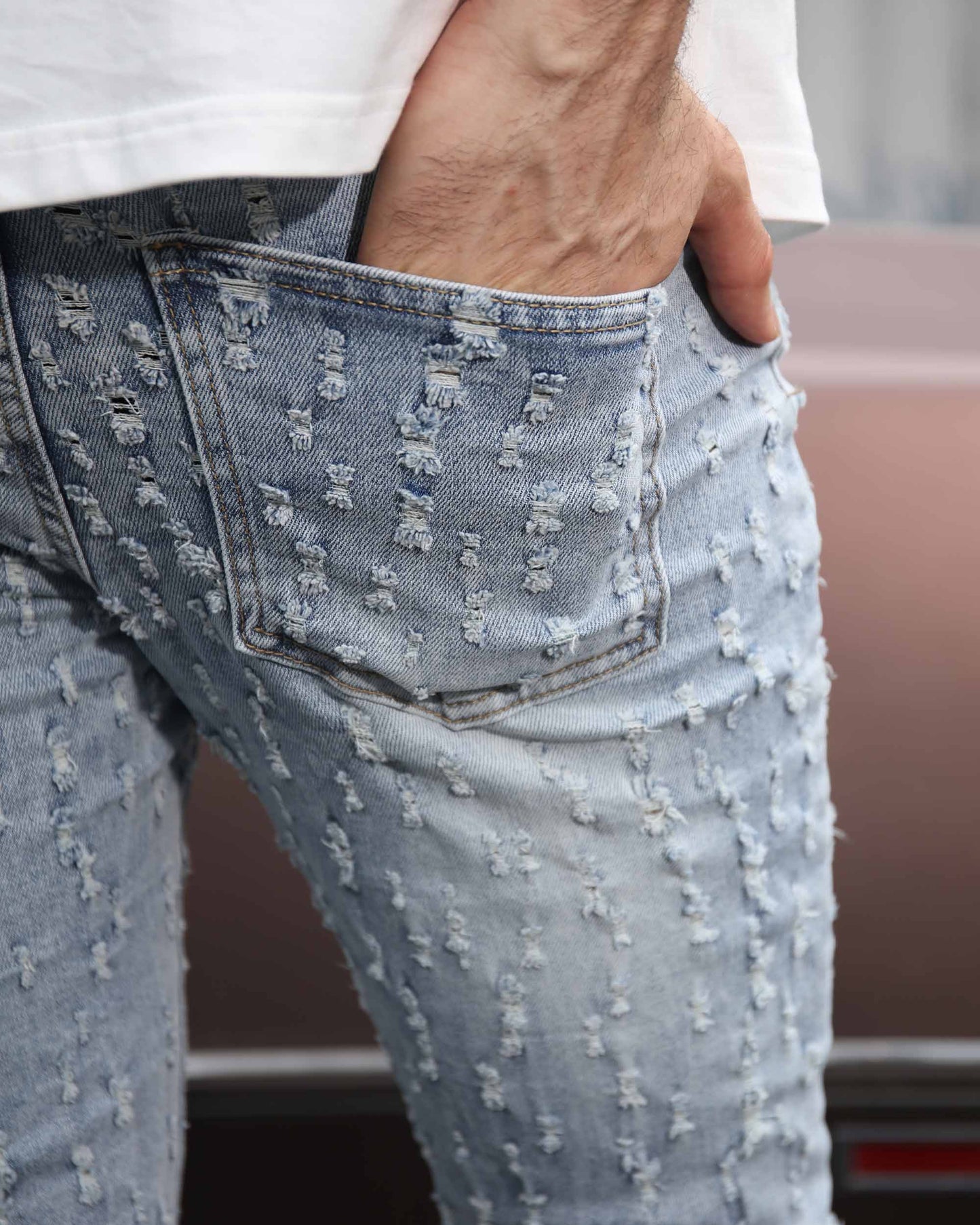 Logeqi slim fit ripped jeans in light wash with distressed detailing and a stylish pocket design