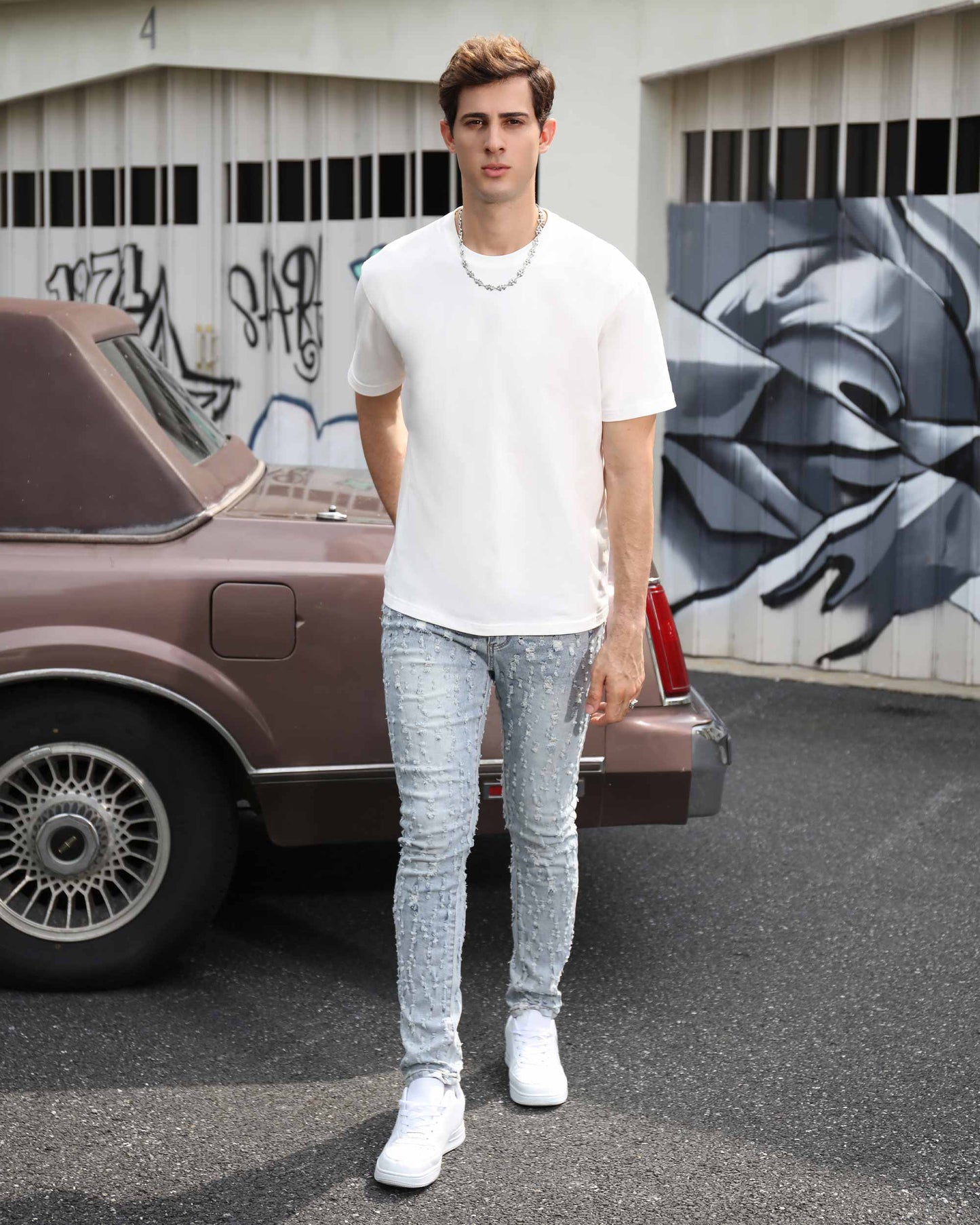 Logeqi slim fit ripped jeans in light wash, styled with a white t-shirt and sneakers