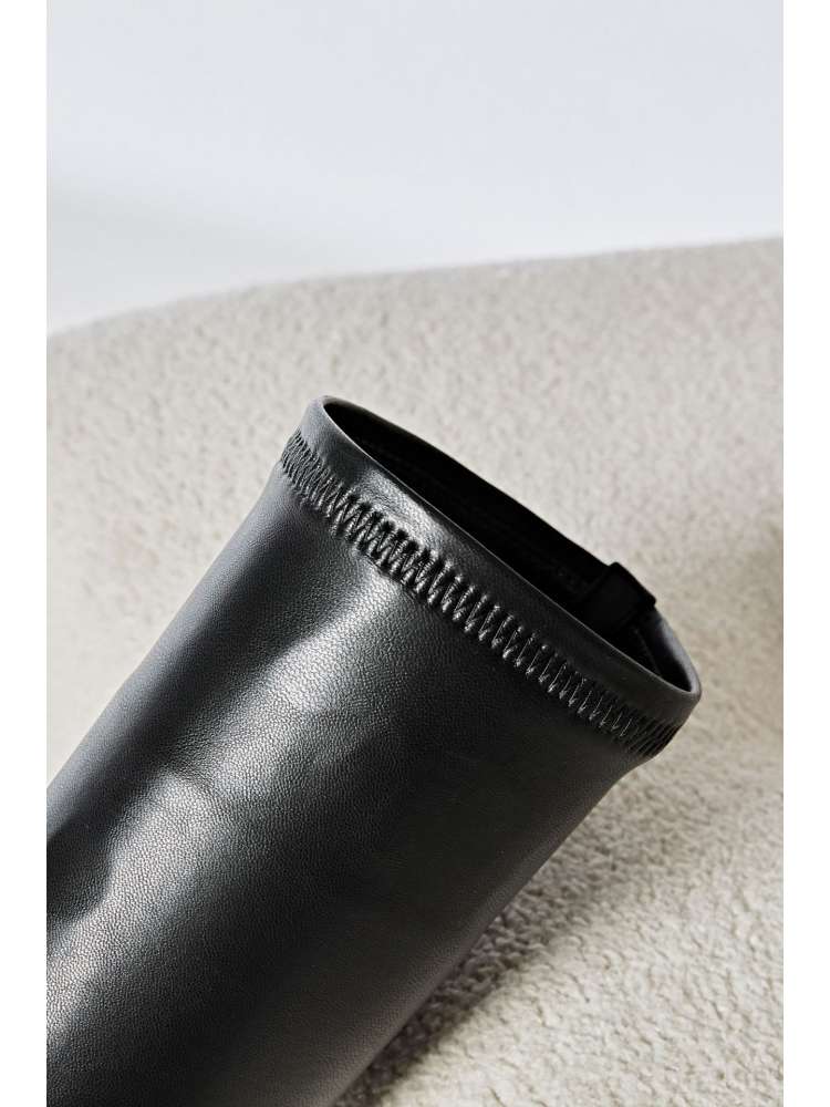 Close-up of black solid PU patchwork boots from wholesale7 showing detailed stitching and smooth finish