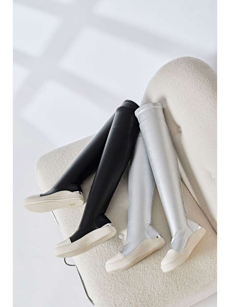Wholesale7 solid PU patchwork boots in black and white over-the-knee style on white chair