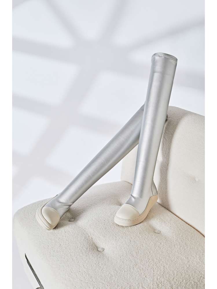 Wholesale7 silver solid PU patchwork boots with knee-high design and rounded toe on beige chair