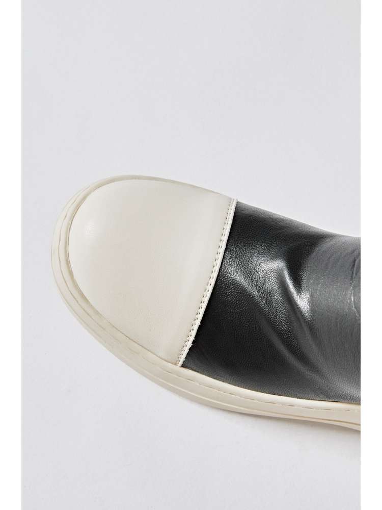 Close-up of solid PU patchwork boots with white toe cap and black body from wholesale7