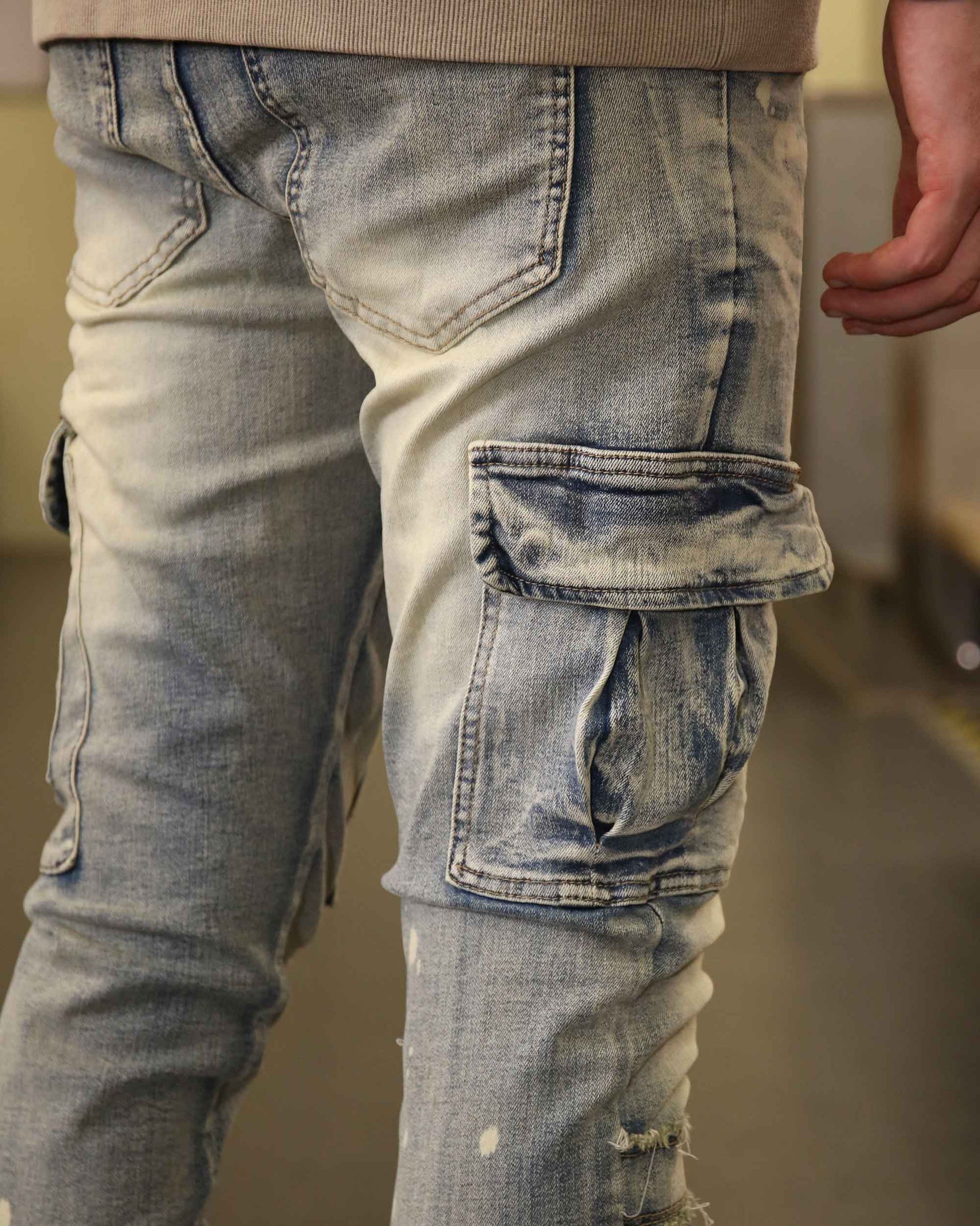 Logeqi spray painted blue cargo jeans with side pocket detailing and a distressed look