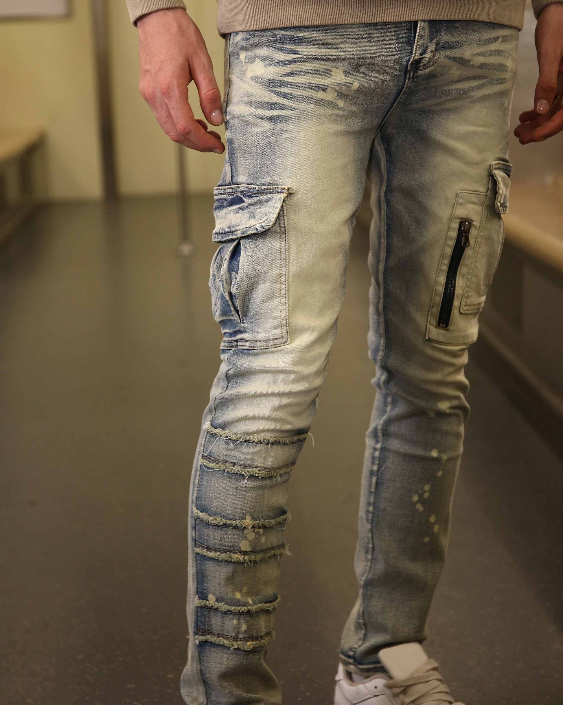 Logeqi spray painted blue cargo jeans with distressed detailing and multiple pockets