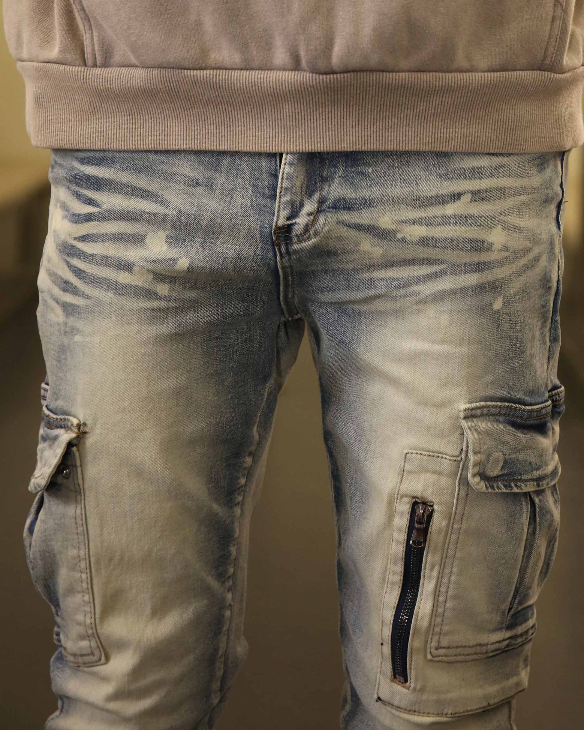 Logeqi spray painted blue cargo jeans with side pockets and zipper details on the legs