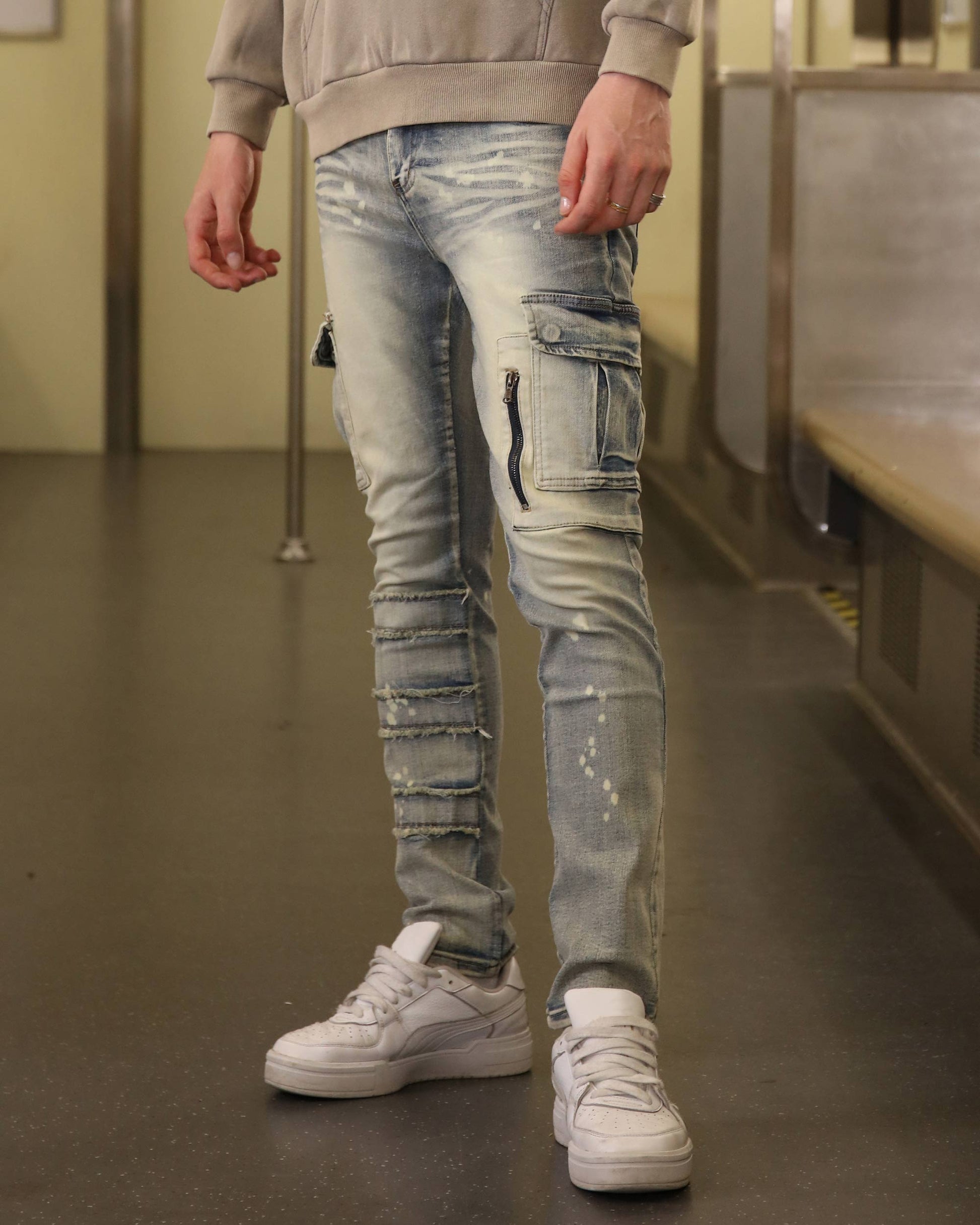 Logeqi spray painted blue cargo jeans with distressed details and side zipper pocket