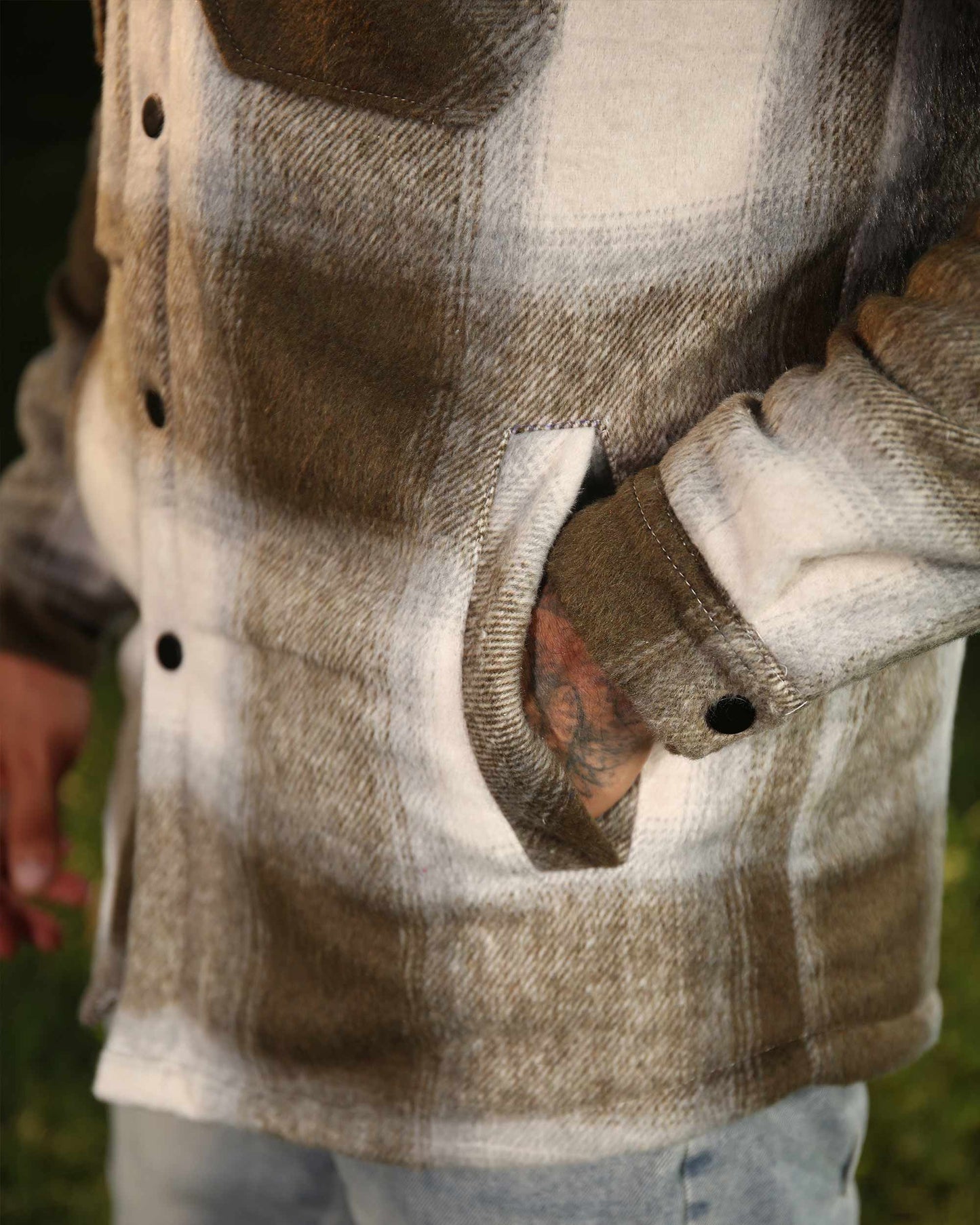 Close-up of Logeqi brown and white spring plaid jacket with button details and front pocket