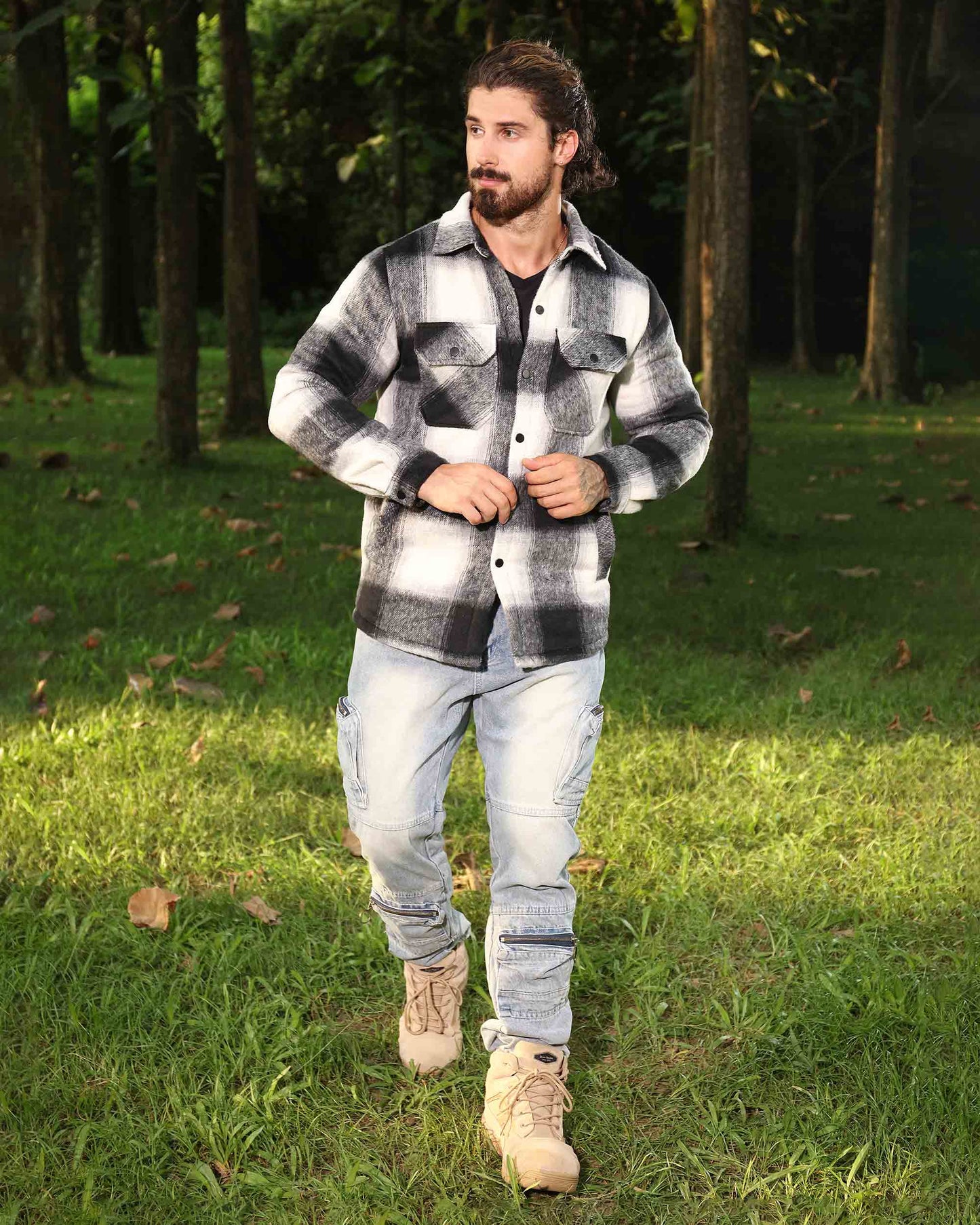Man wearing Logeqi spring plaid jacket in black and white outdoors in a forest setting