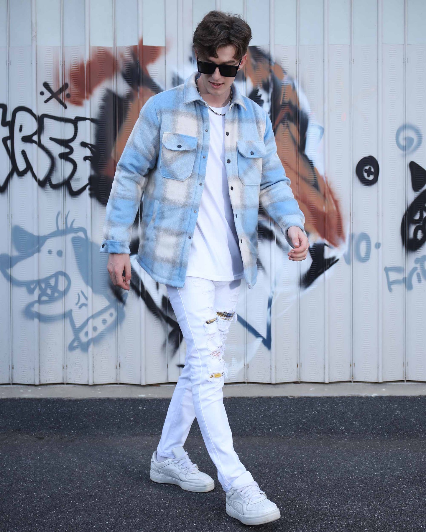 Man wearing Logeqi spring plaid jacket in blue and white with ripped white jeans and sunglasses