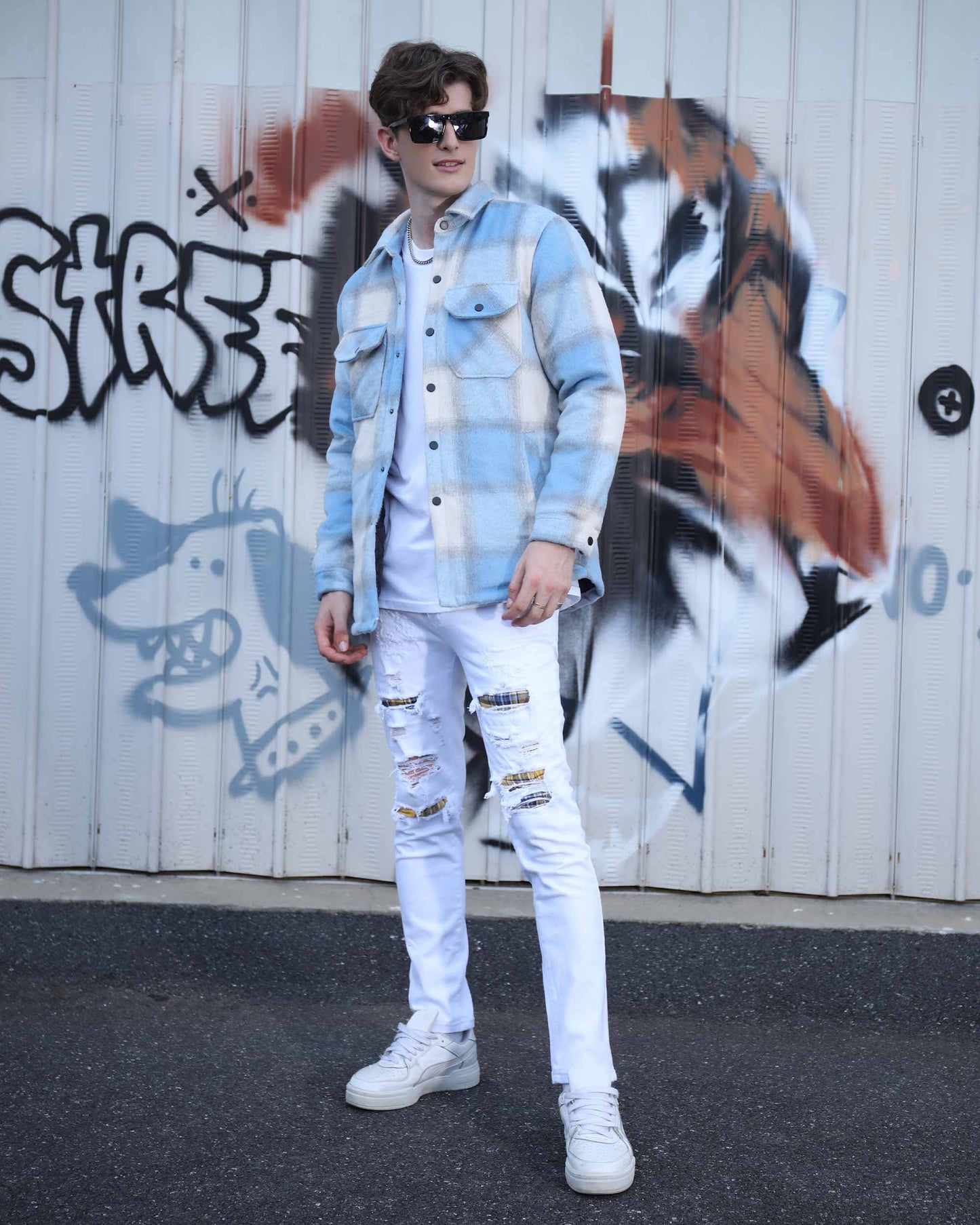 Man wearing Logeqi spring plaid jacket in blue and white with white ripped jeans and sneakers