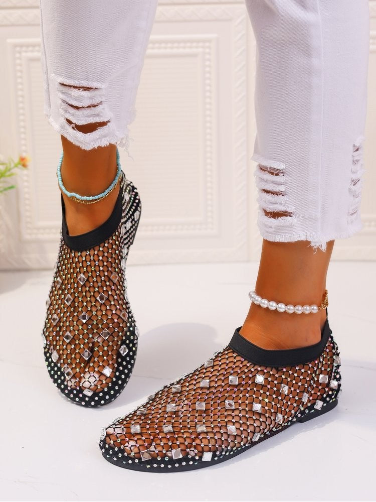 Stylish solid color sandals with a mesh design and white embellishments worn with white ripped pants
