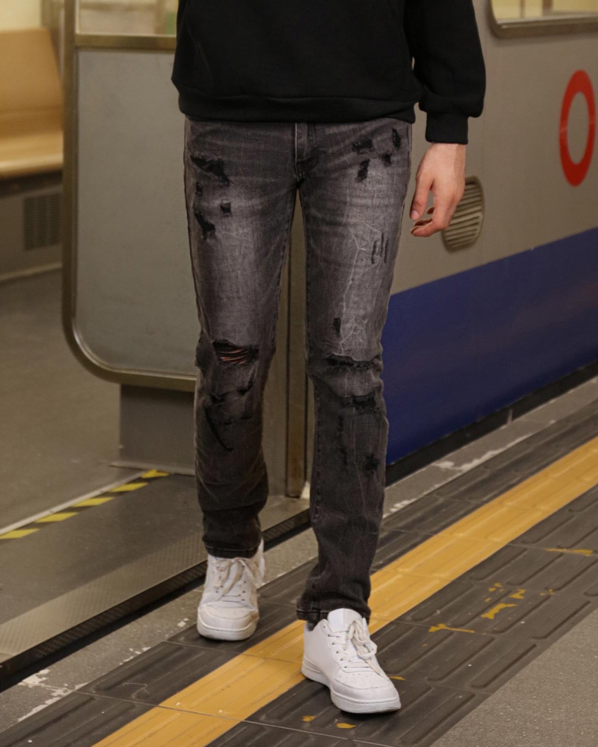 Logeqi stylish straight leg jeans in distressed black denim worn with white sneakers