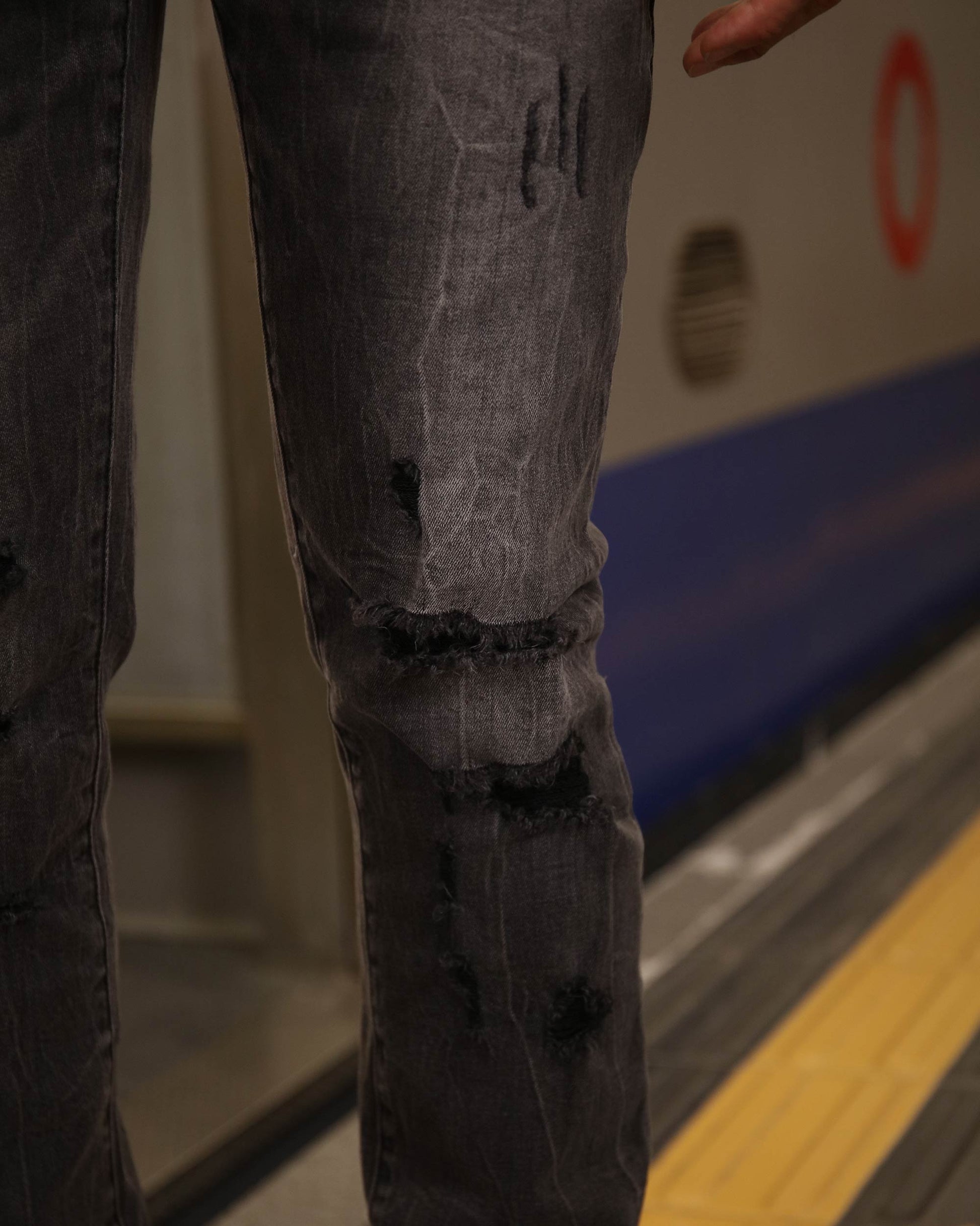 Close-up of Logeqi stylish straight leg jeans in distressed black denim fabric