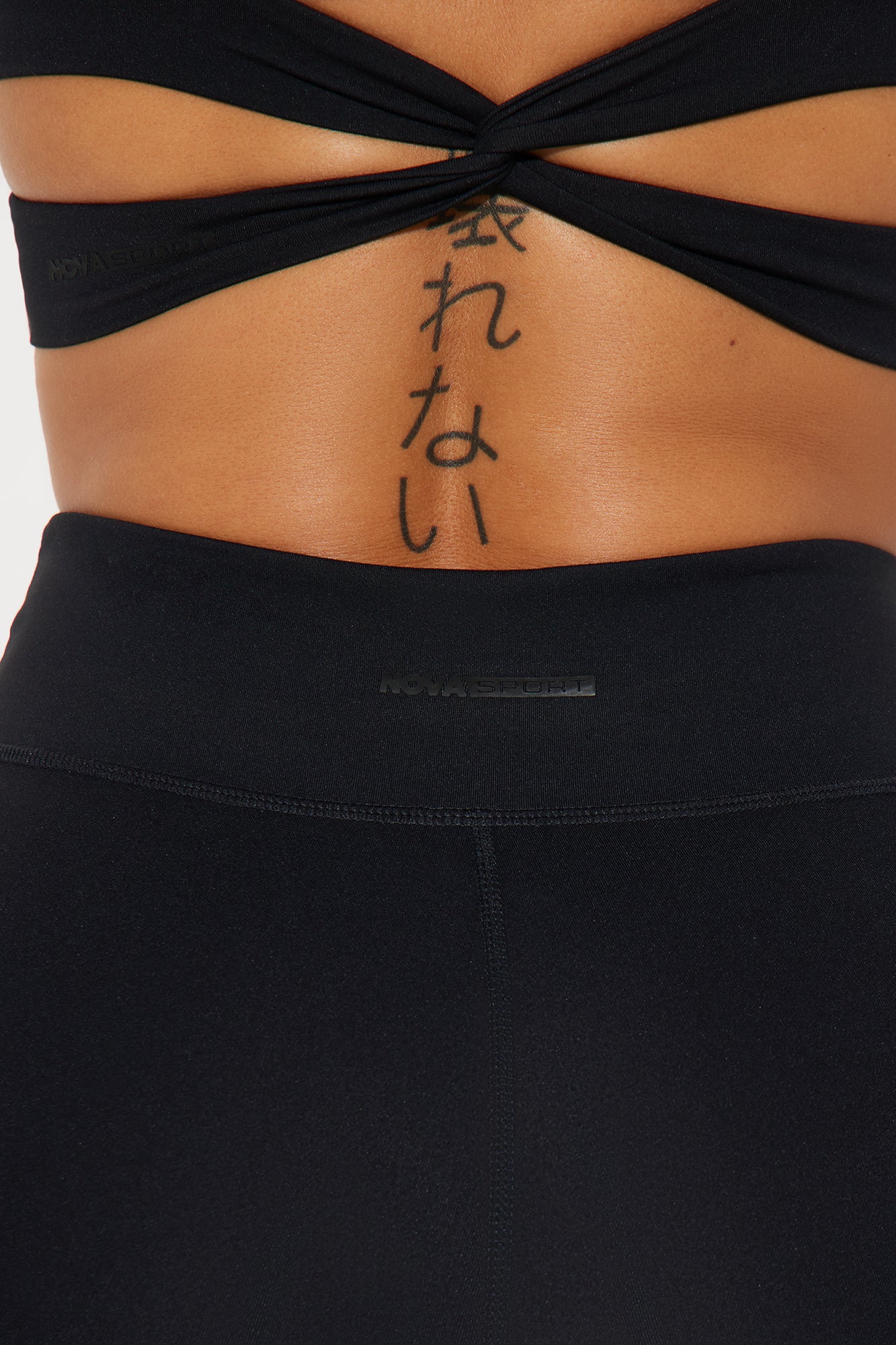 Close-up of waistband detailing on super soft black yoga pants from Fashion Nova