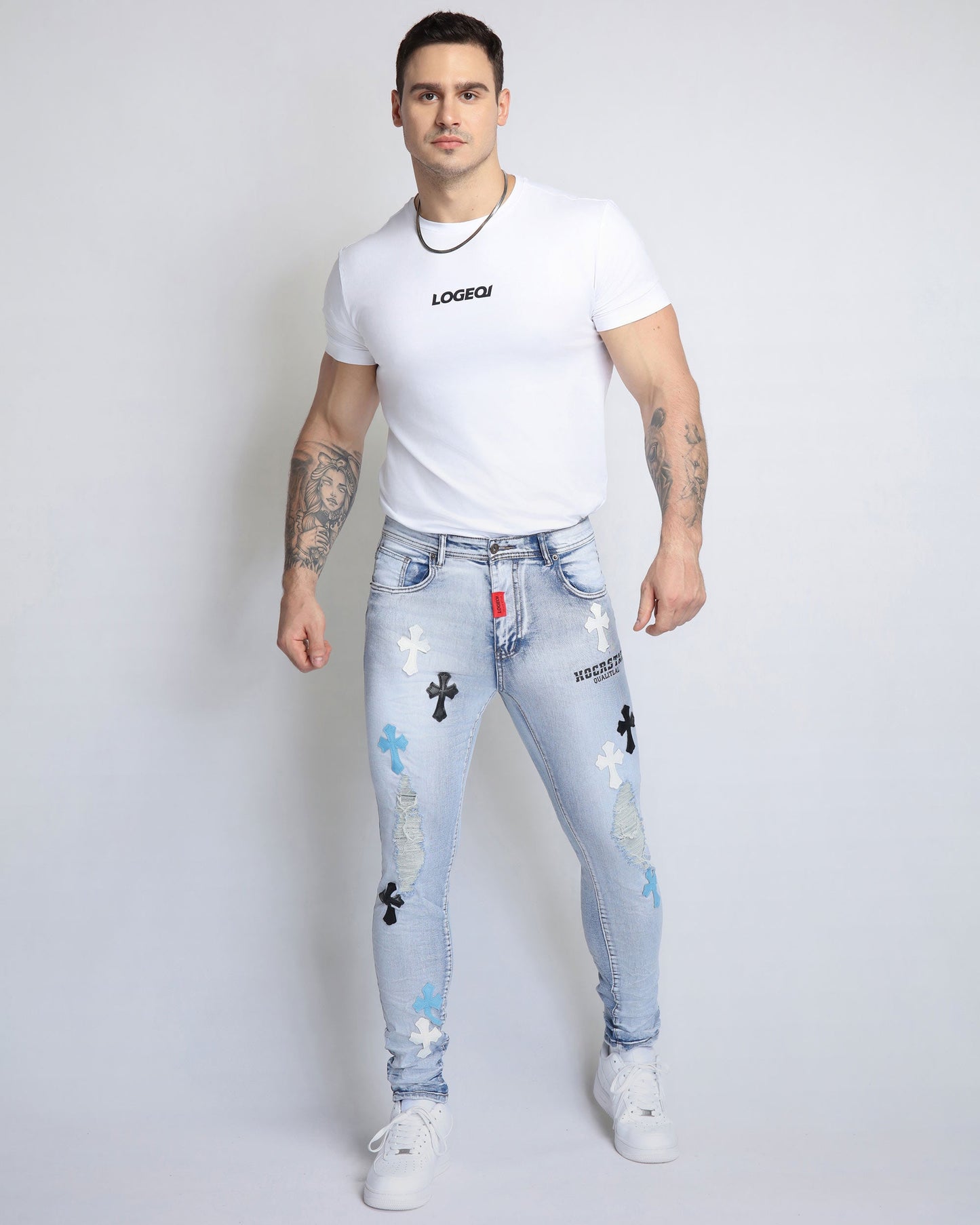 Trendy distressed jeans from Logeqi with colorful cross embellishments for a stylish look