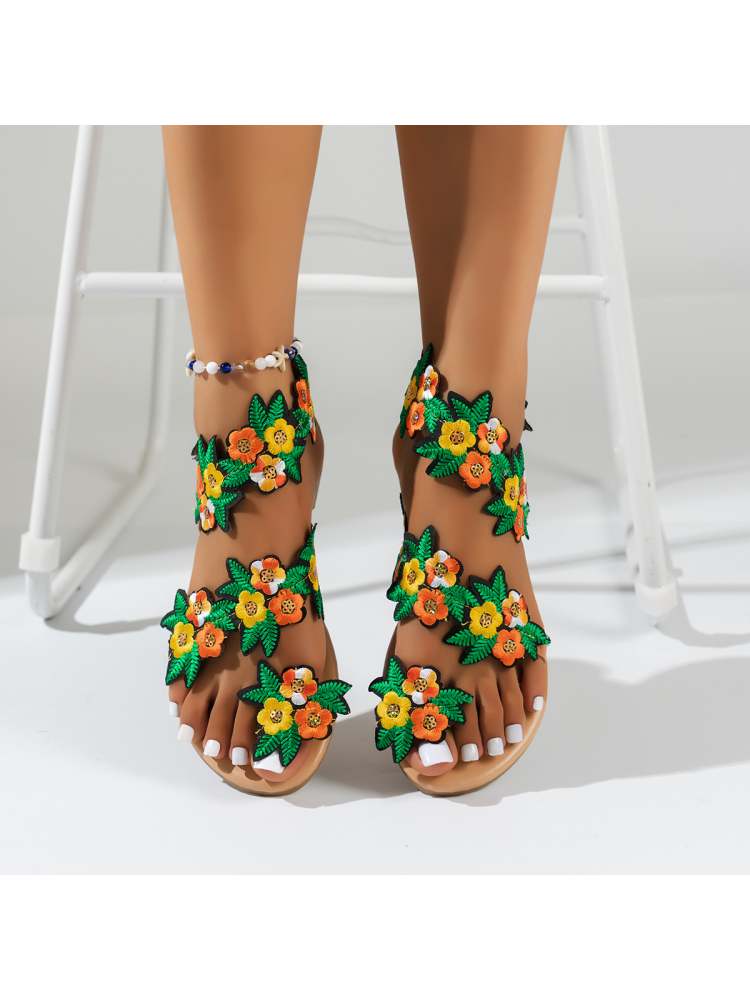 Wholesale7 tropical flower sandals with colorful embroidered floral design on tan feet