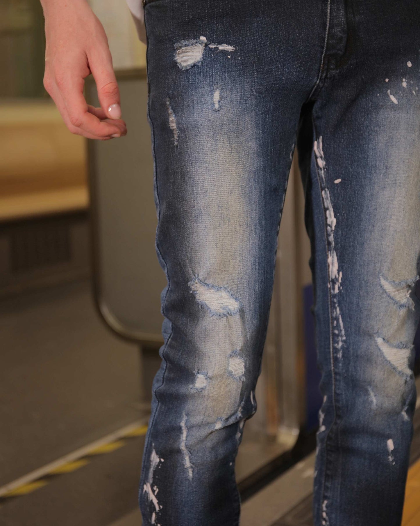 Logeqi unique blue wash jeans with distressed details on a person standing indoors