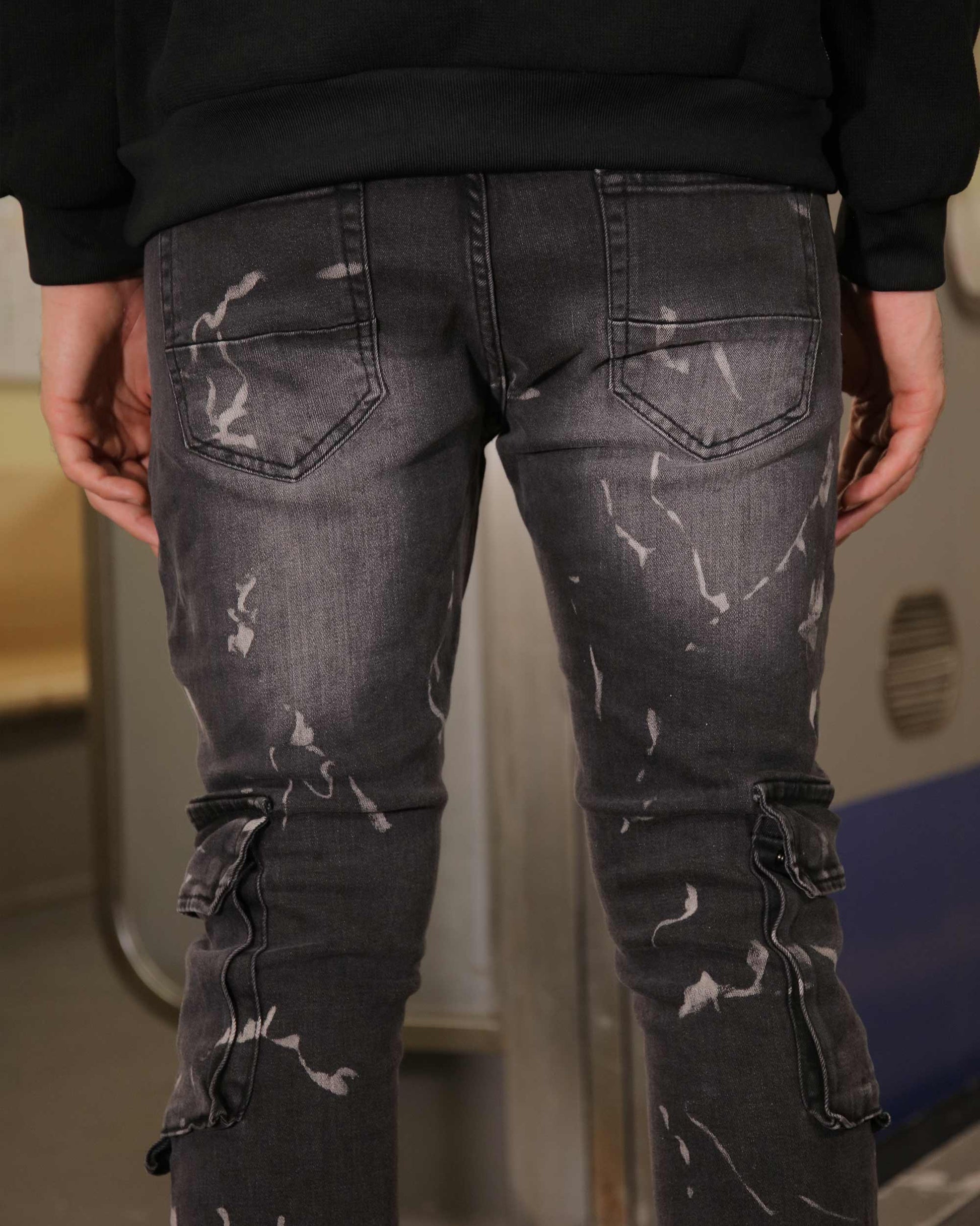 Logeqi distressed black cargo jeans with multiple pockets and unique paint splatter design
