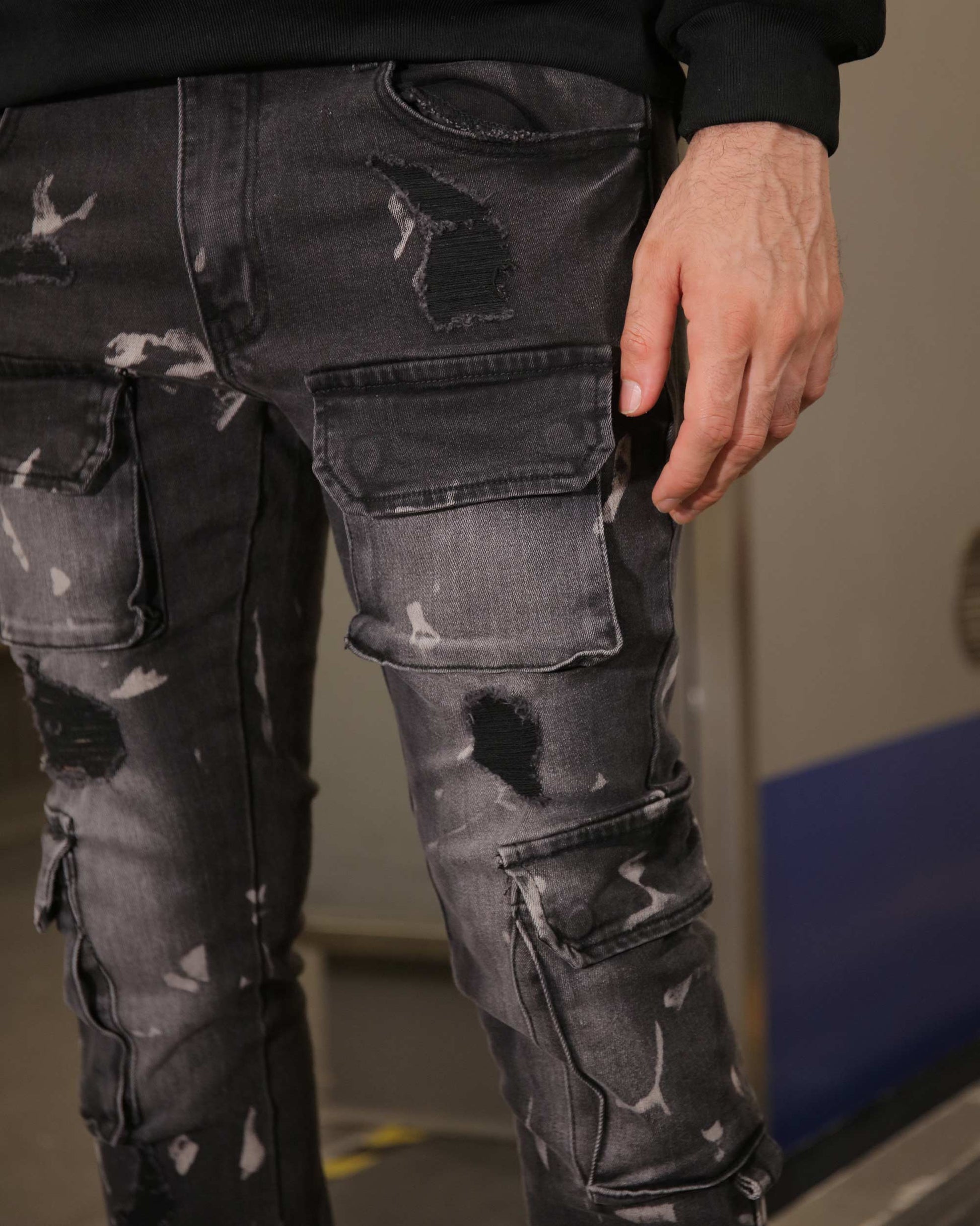 Logeqi distressed black cargo jeans featuring multiple pockets and a worn, rugged design