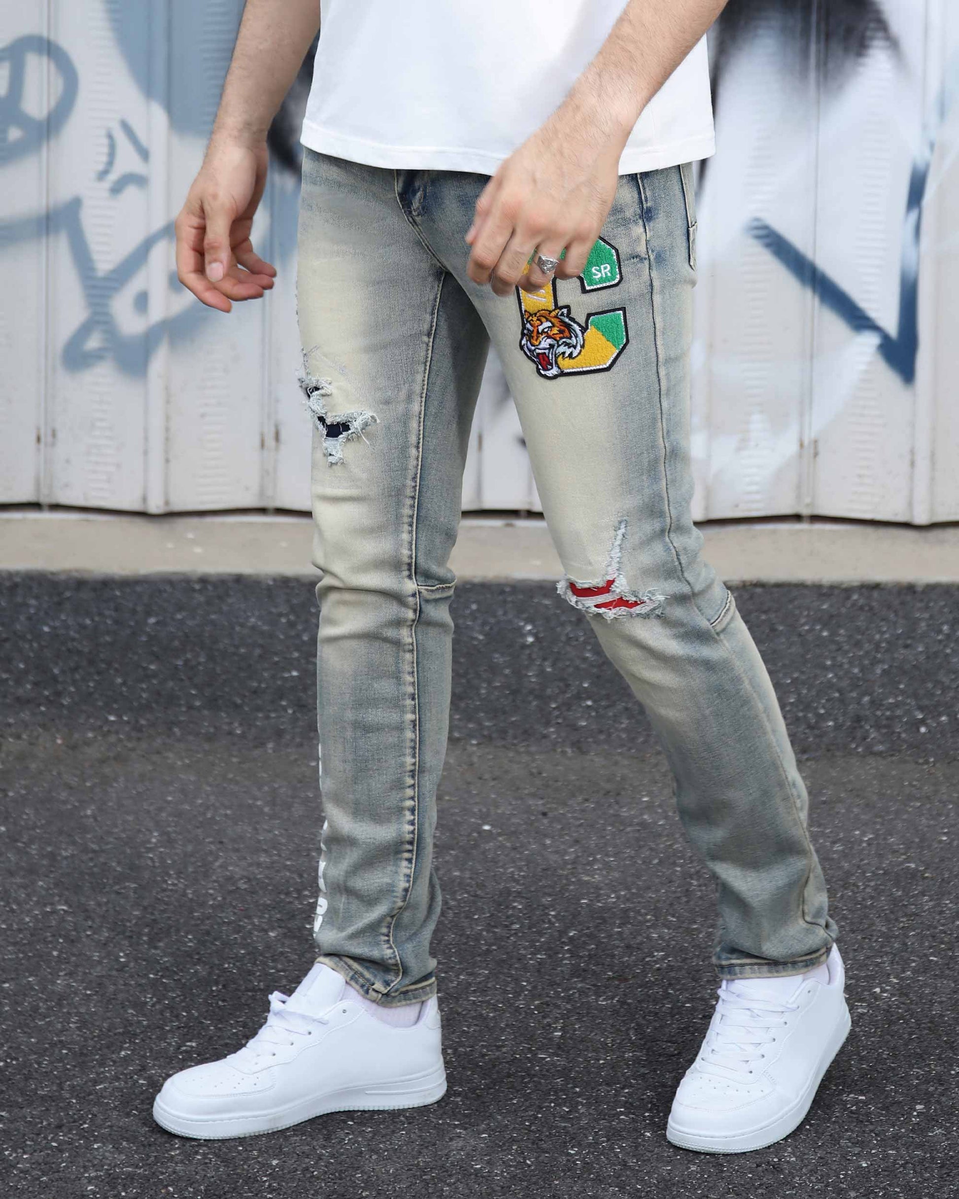 Logeqi distressed light wash jeans with patches and rips worn with white sneakers