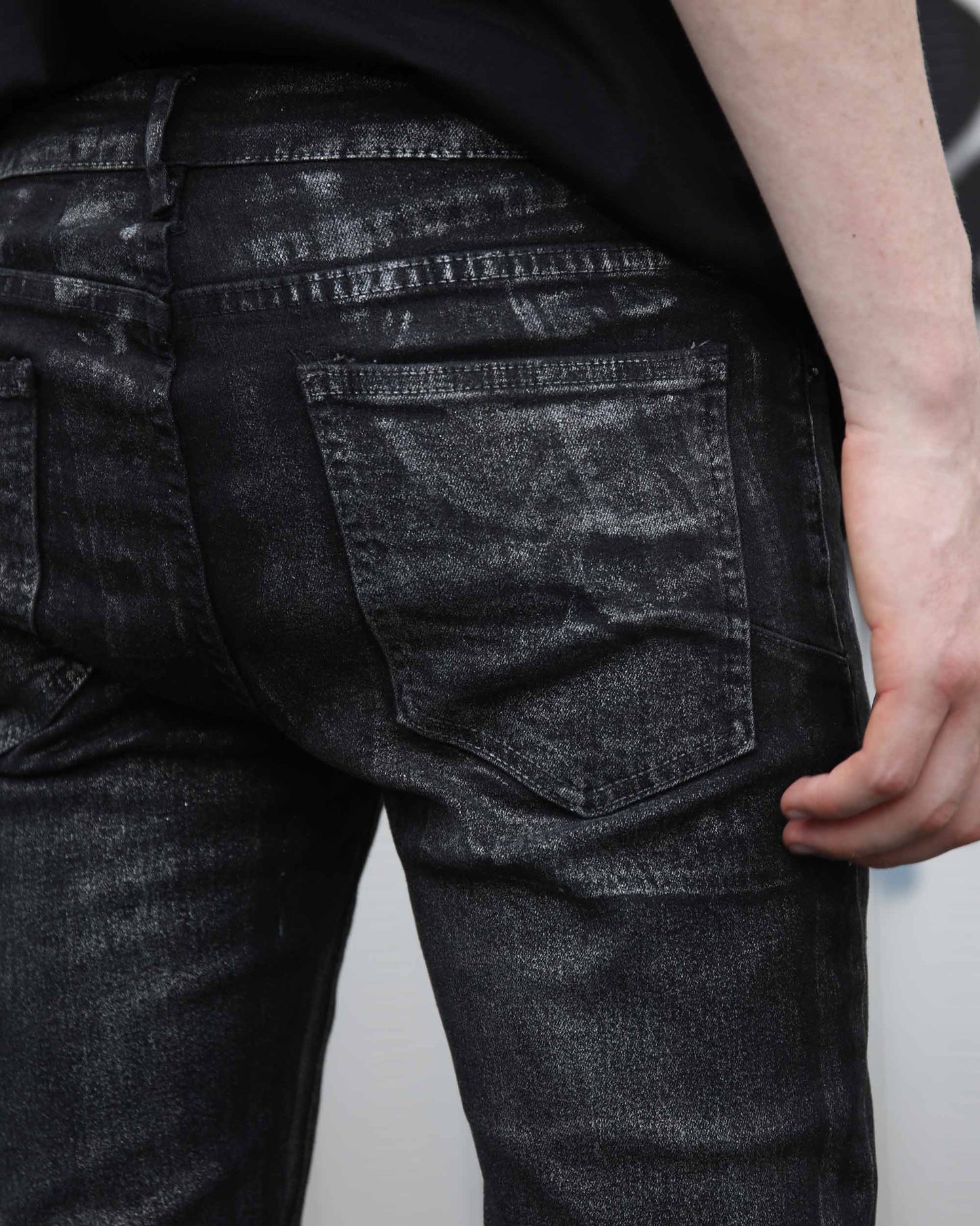 Logeqi gradient ripped black jeans close-up showing back pocket and distressed texture