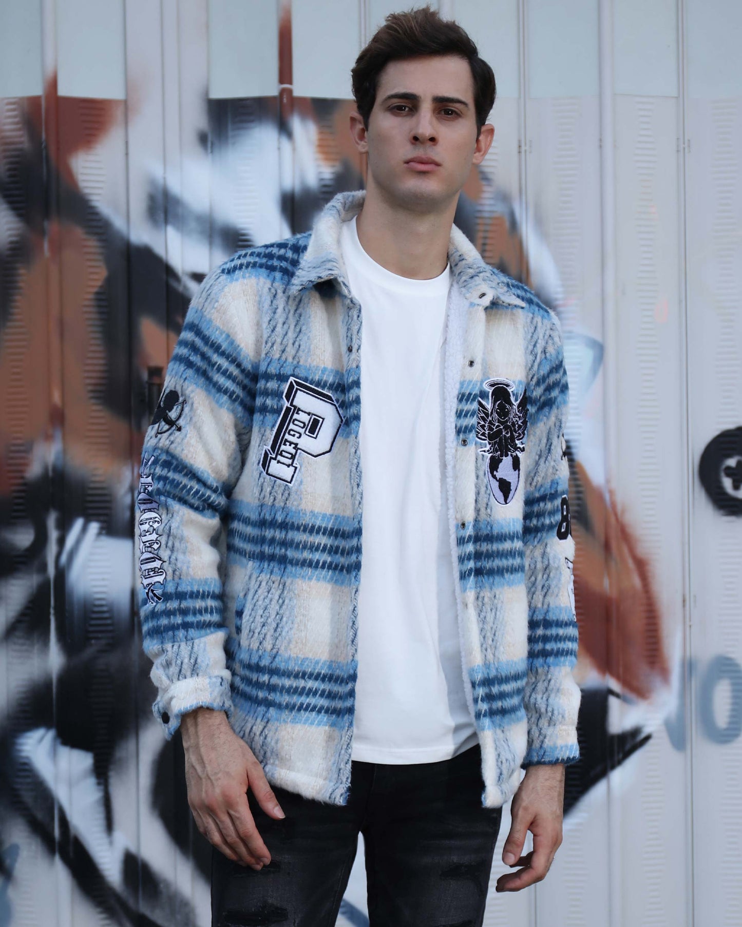 Logeqi insulated plaid moto jacket in blue and white worn by man standing against graffiti wall