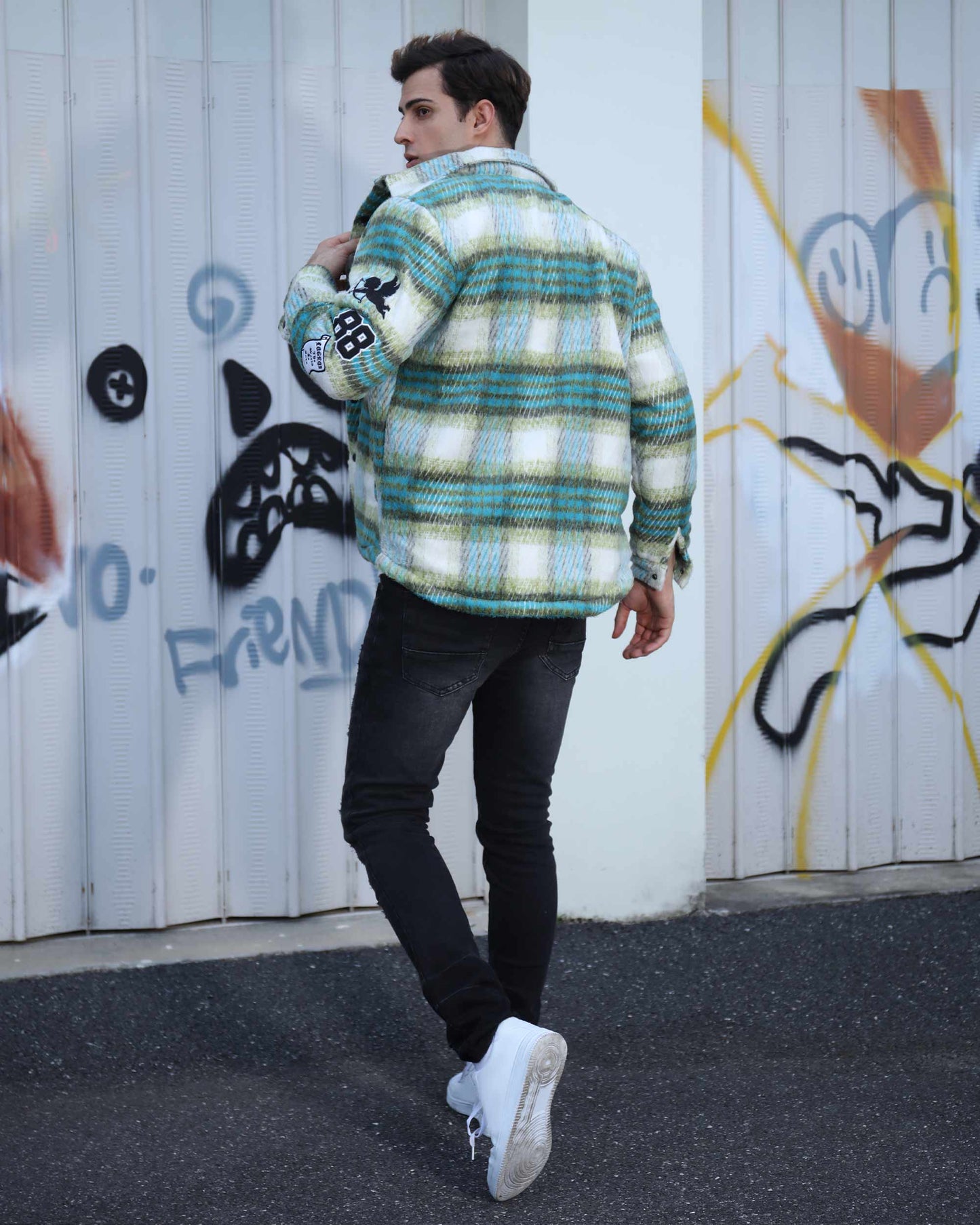 Logeqi insulated plaid moto jacket in green white and blue worn by man with black jeans and white sneakers