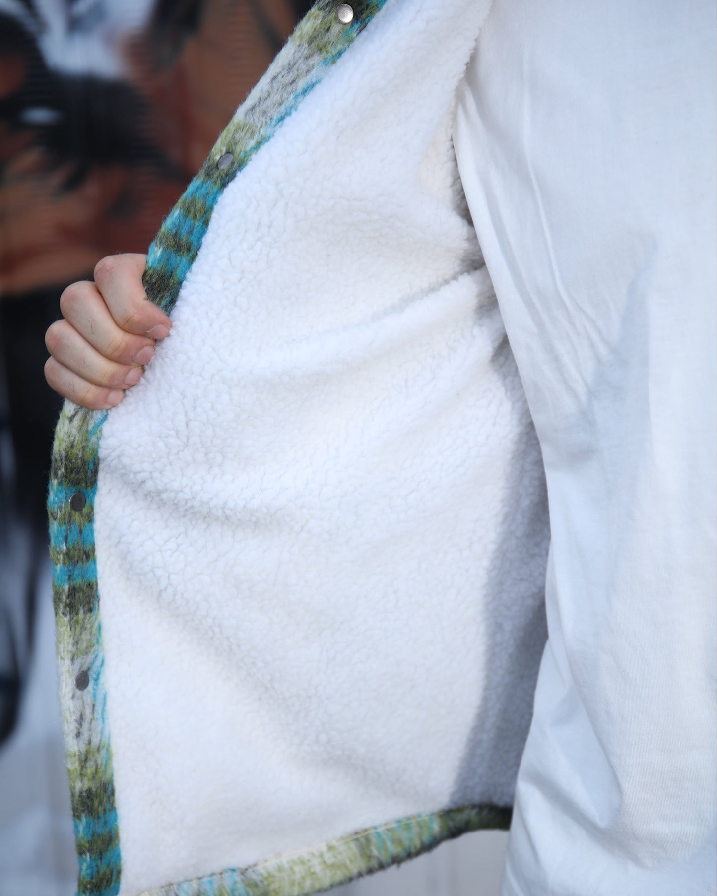 Inside view of Logeqi insulated plaid moto jacket showing soft white fleece lining for warmth