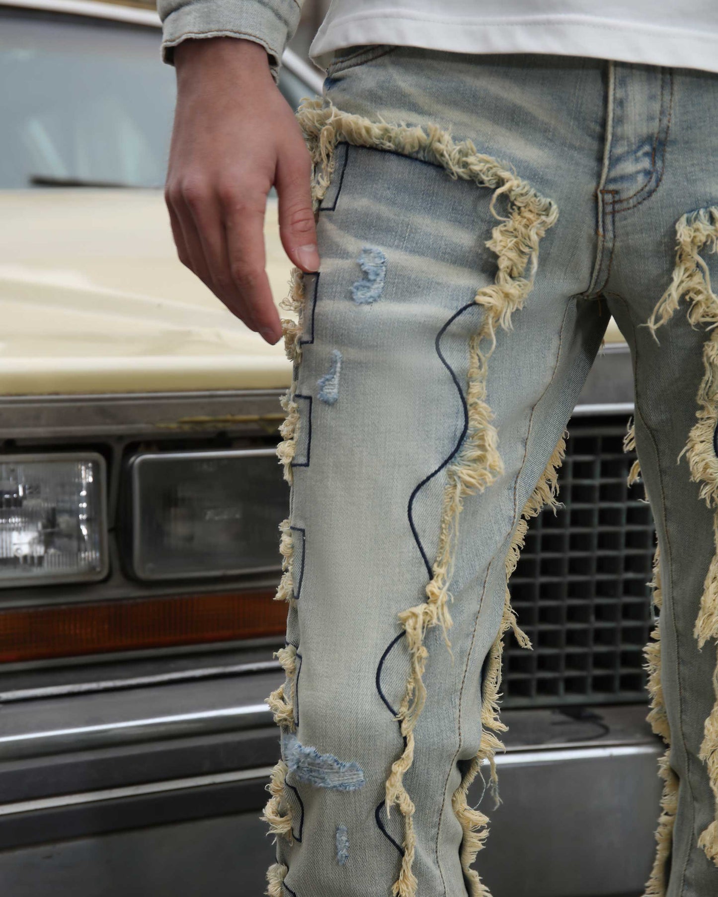 Logeqi vintage blue stacked jeans with distressed frayed detailing on the front legs
