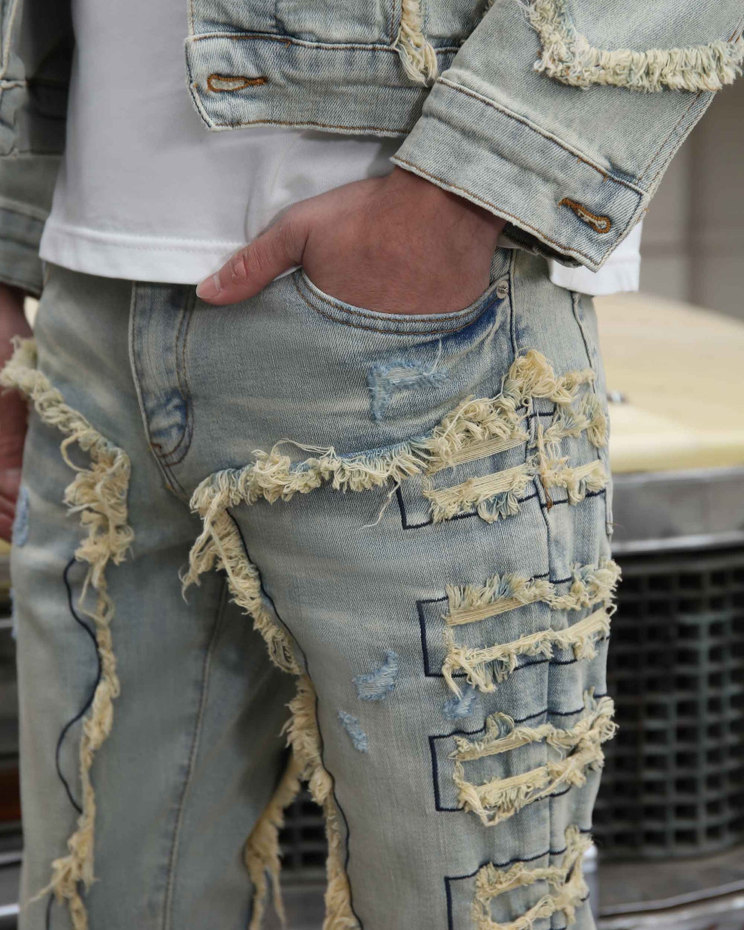 Logeqi vintage blue stacked jeans with distressed and frayed detailing on the thigh and knee areas